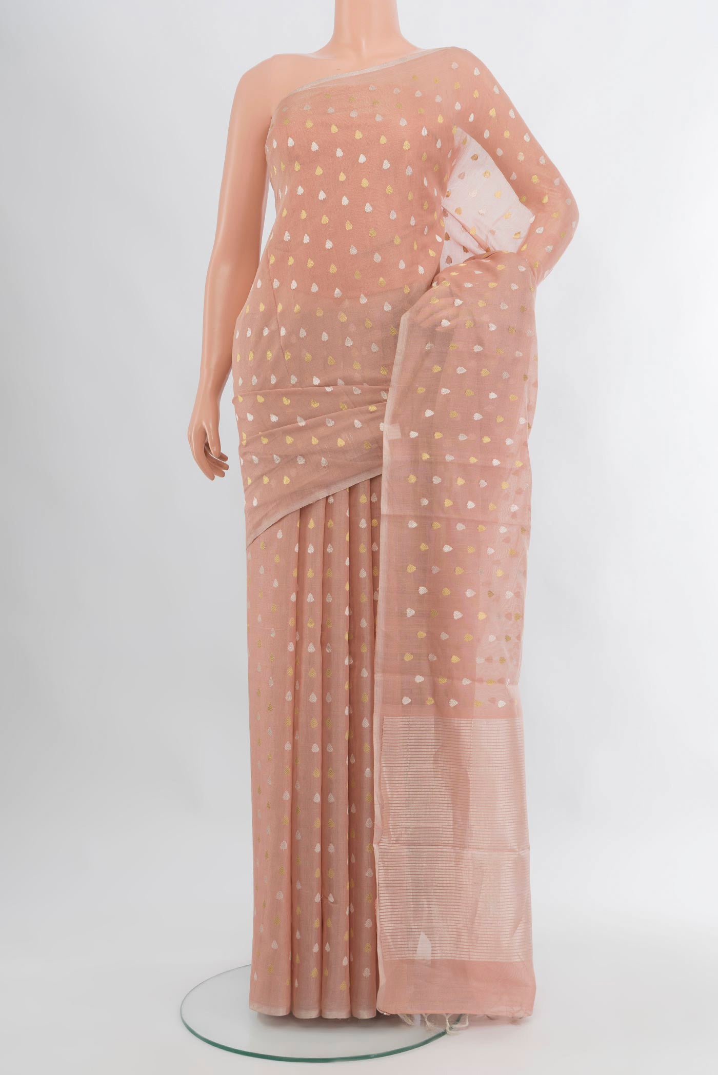 Rose Gold Tussar Silk Saree with Zari Butta on the body and Zari Border.  displayed on a mannequin