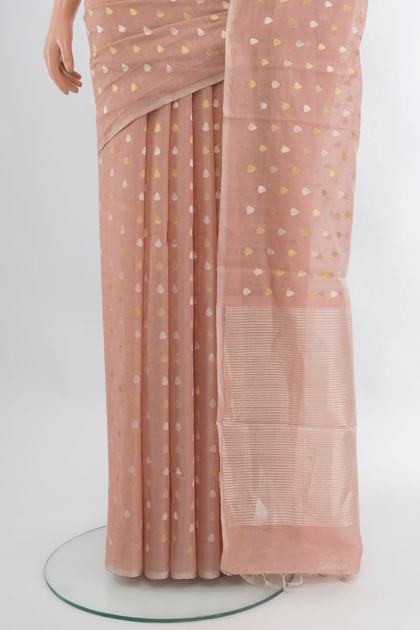 Pleats and pallu of Rose Gold Tussar Silk Saree with Zari Butta on the body and Zari Border. 