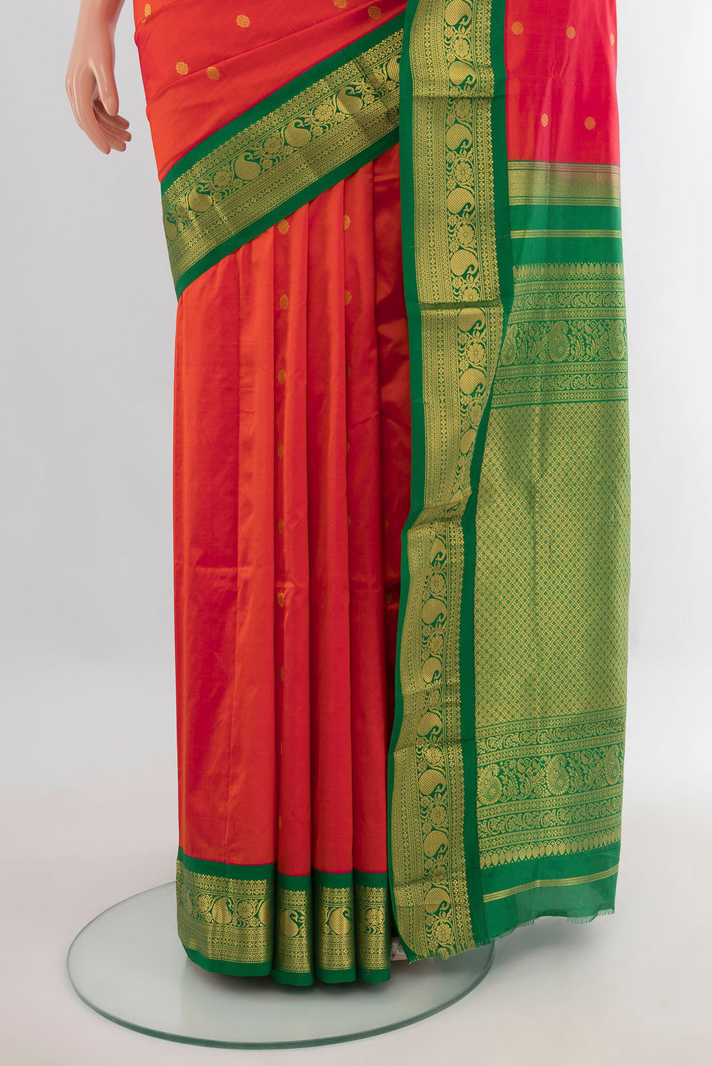 Pleats and pallu of Pure Silk Orange Bangalore - kadyal Saree with Zari Butta on the body and Zari Border. 