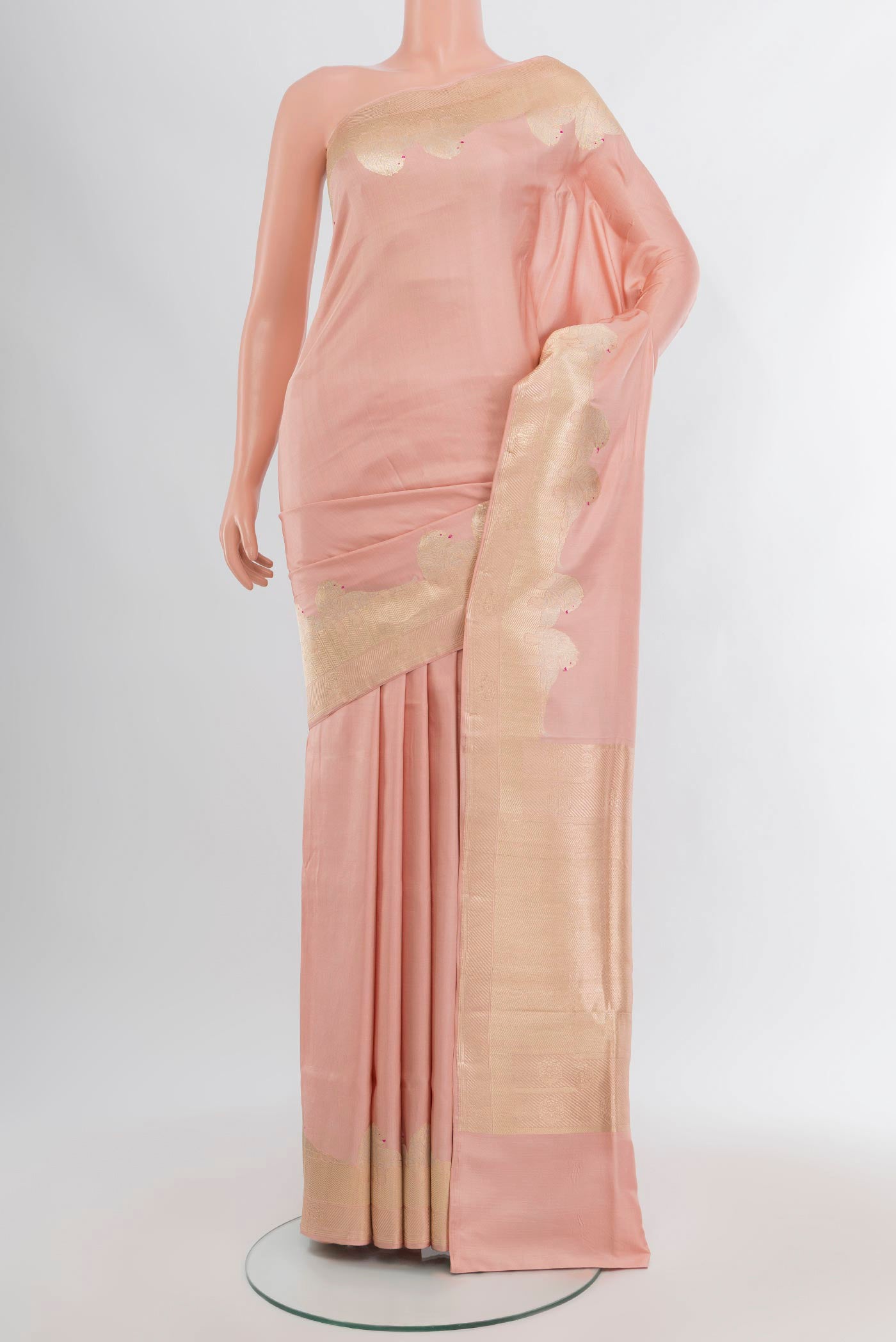 Rose Gold Banarasi Katan Silk Saree with Plain Body and Zari Border.  displayed on a mannequin