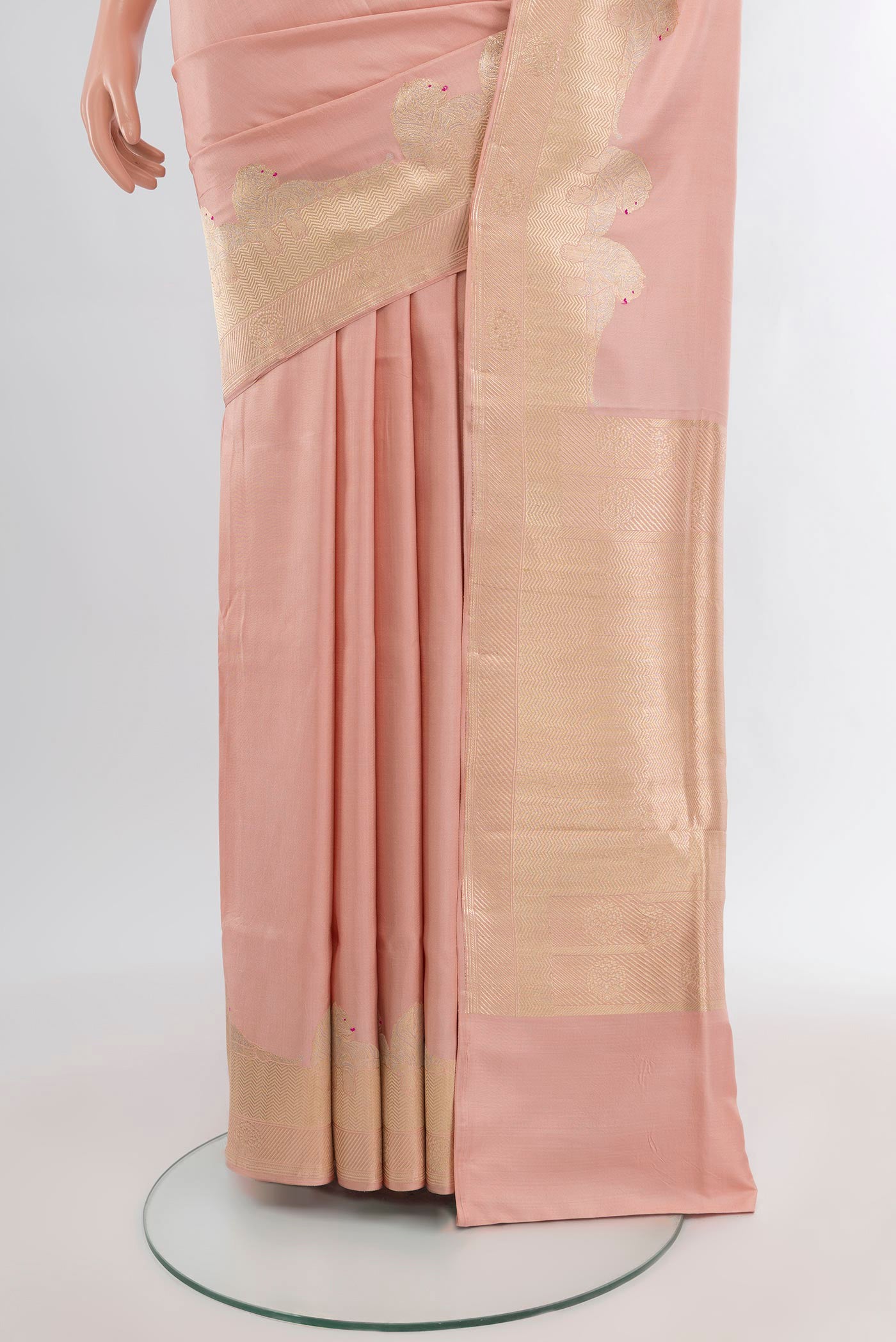Pleats and pallu of Rose Gold Banarasi Katan Silk Saree with Plain Body and Zari Border. 