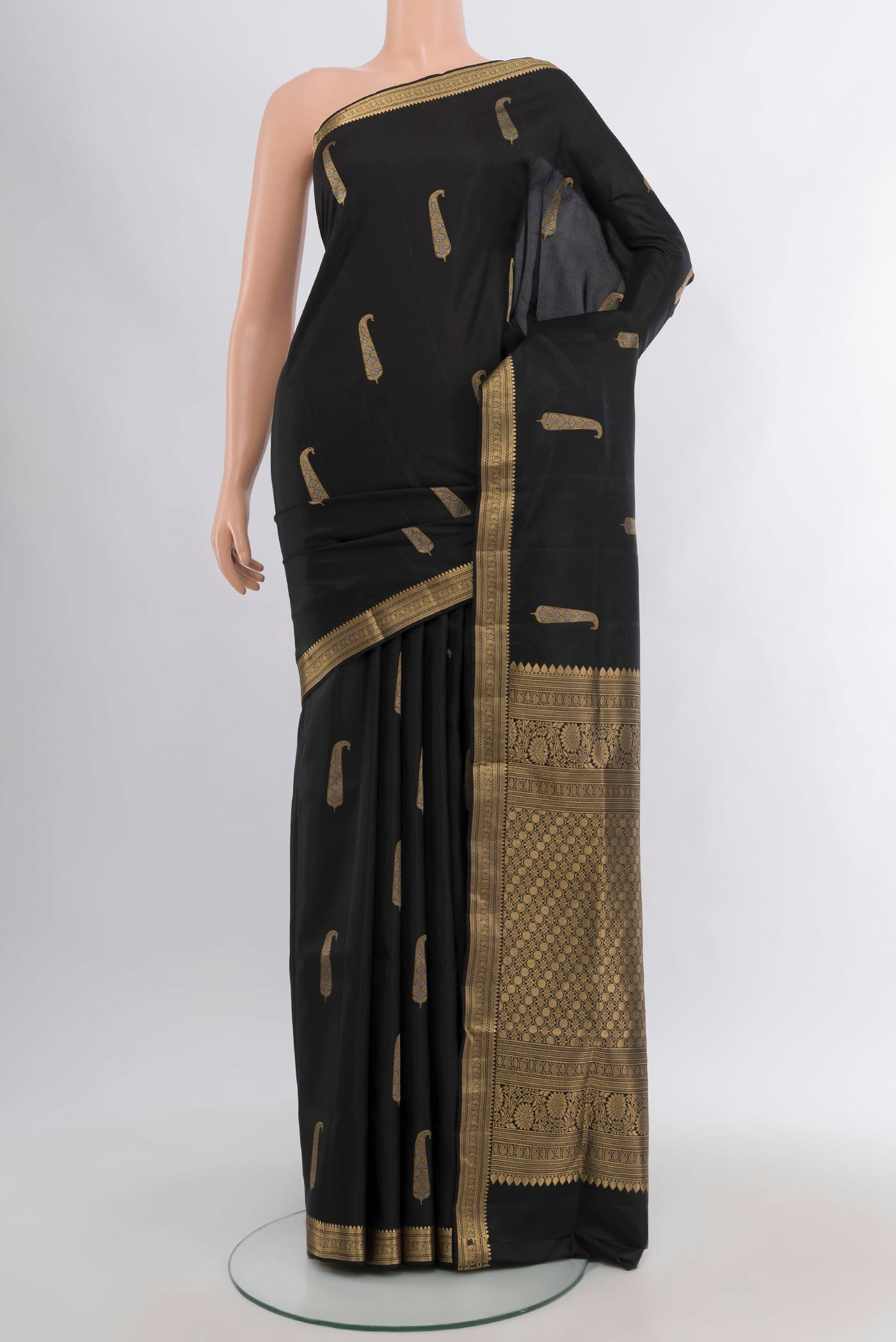 Black Soft Silk Saree with Zari Butta on the body and Zari Border.  displayed on a mannequin