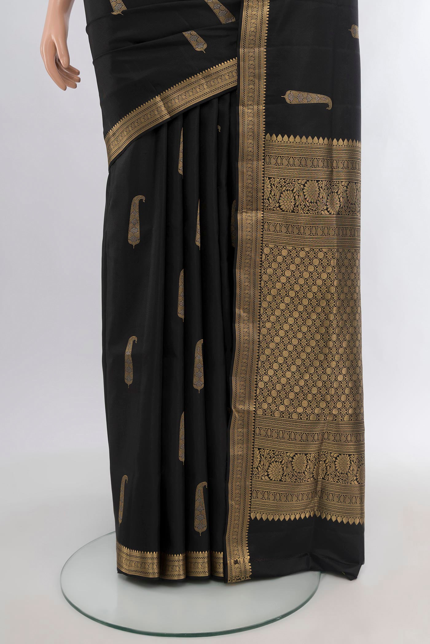 Pleats and pallu of Black Soft Silk Saree with Zari Butta on the body and Zari Border. 