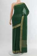 Bottle Green Mysore Crepe Saree with Plain Body and Zari Border.  displayed on a mannequin