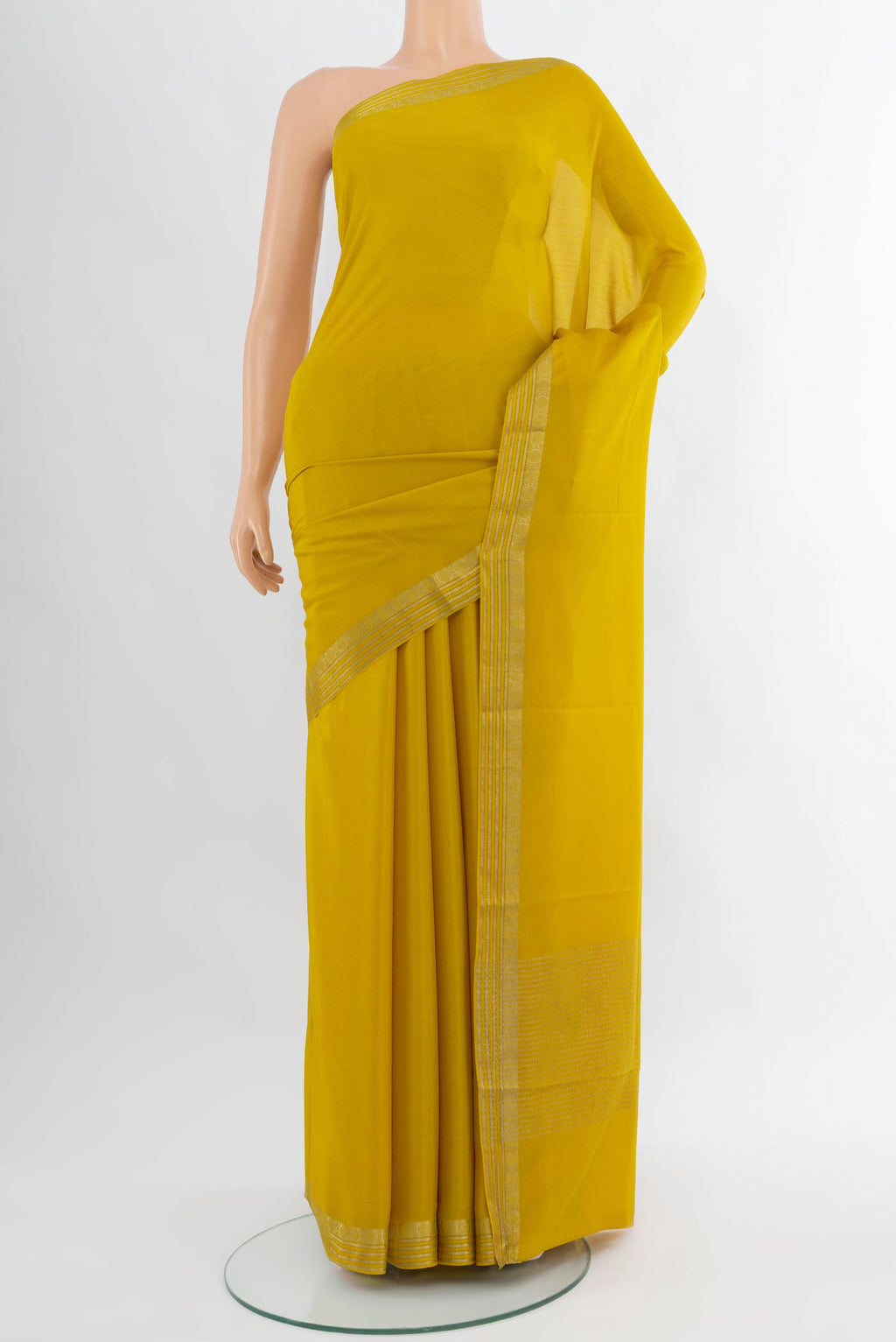 Mustard Mysore Crepe Saree with Plain Body and Zari Border.  displayed on a mannequin