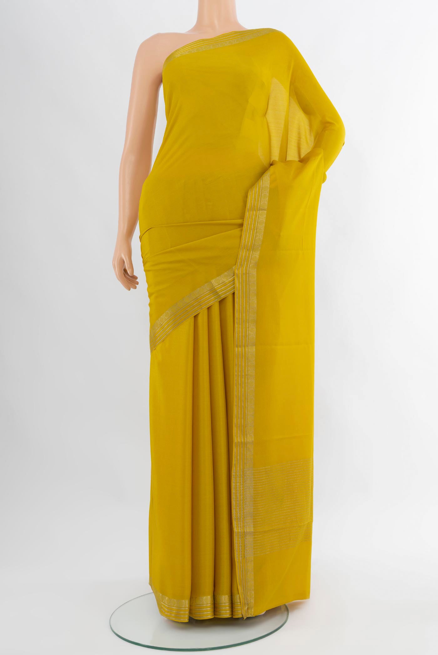 Mustard Mysore Crepe Saree with Plain Body and Zari Border.  displayed on a mannequin