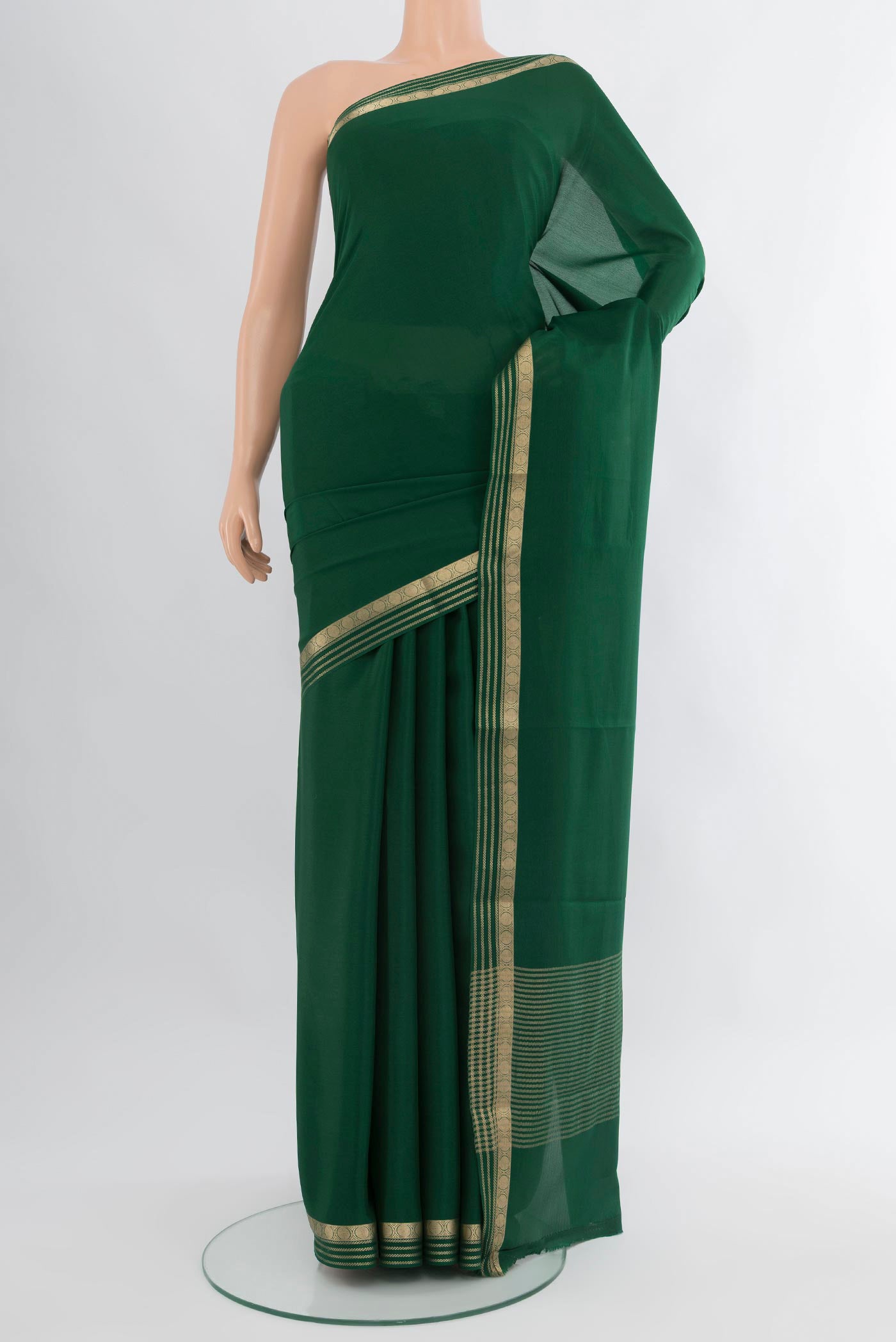 Bottle Green Mysore Crepe Saree with Plain Body and Zari Border.  displayed on a mannequin