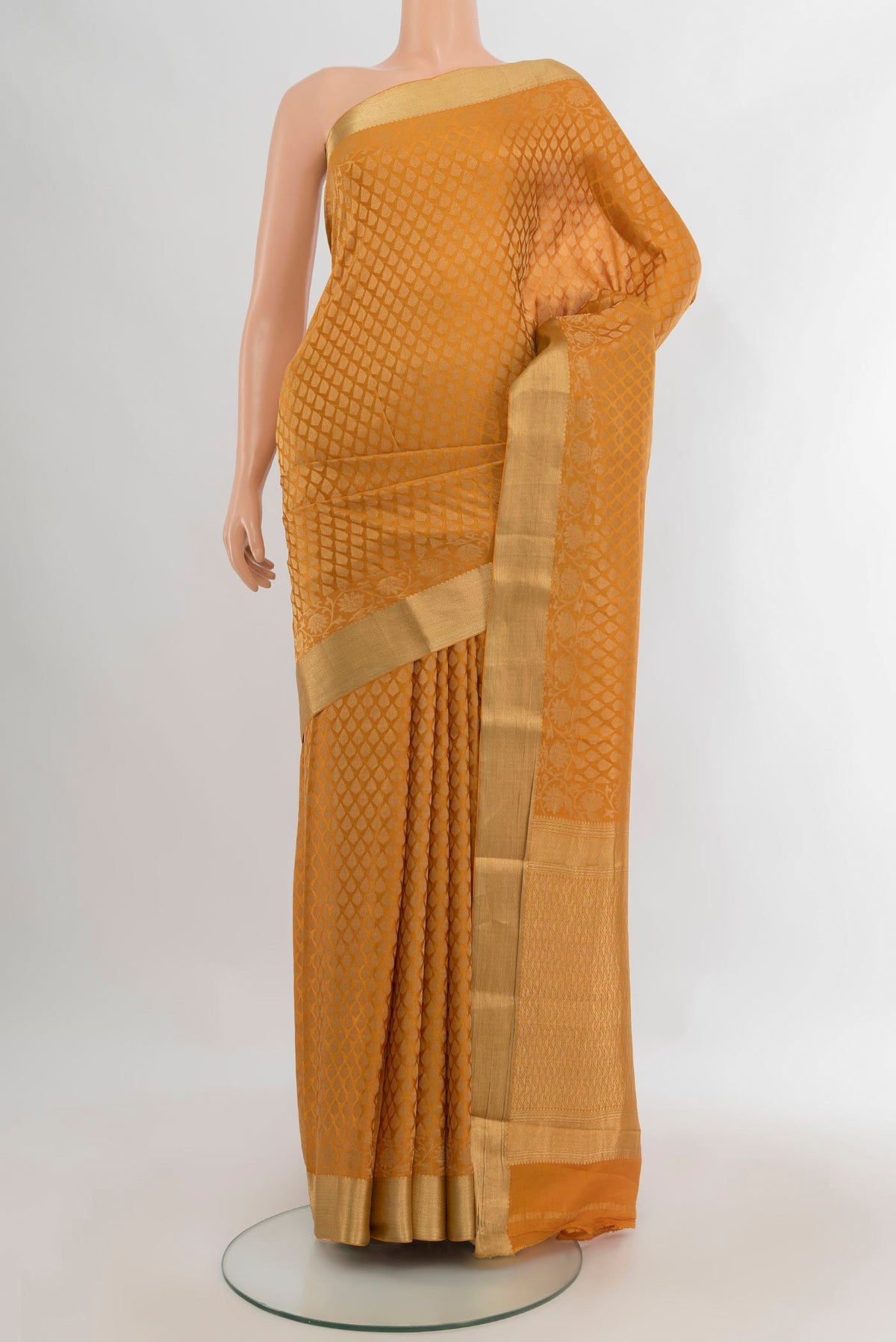 Mustard Mysore Crepe Saree with Zari Brocade on the body and Zari Border.  displayed on a mannequin