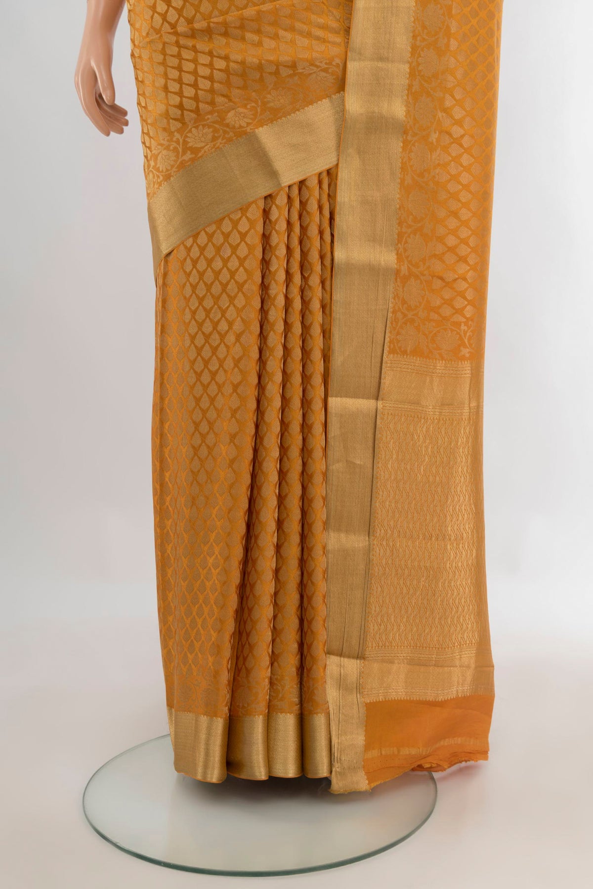 Pleats and pallu of Mustard Mysore Crepe Saree with Zari Brocade on the body and Zari Border. 