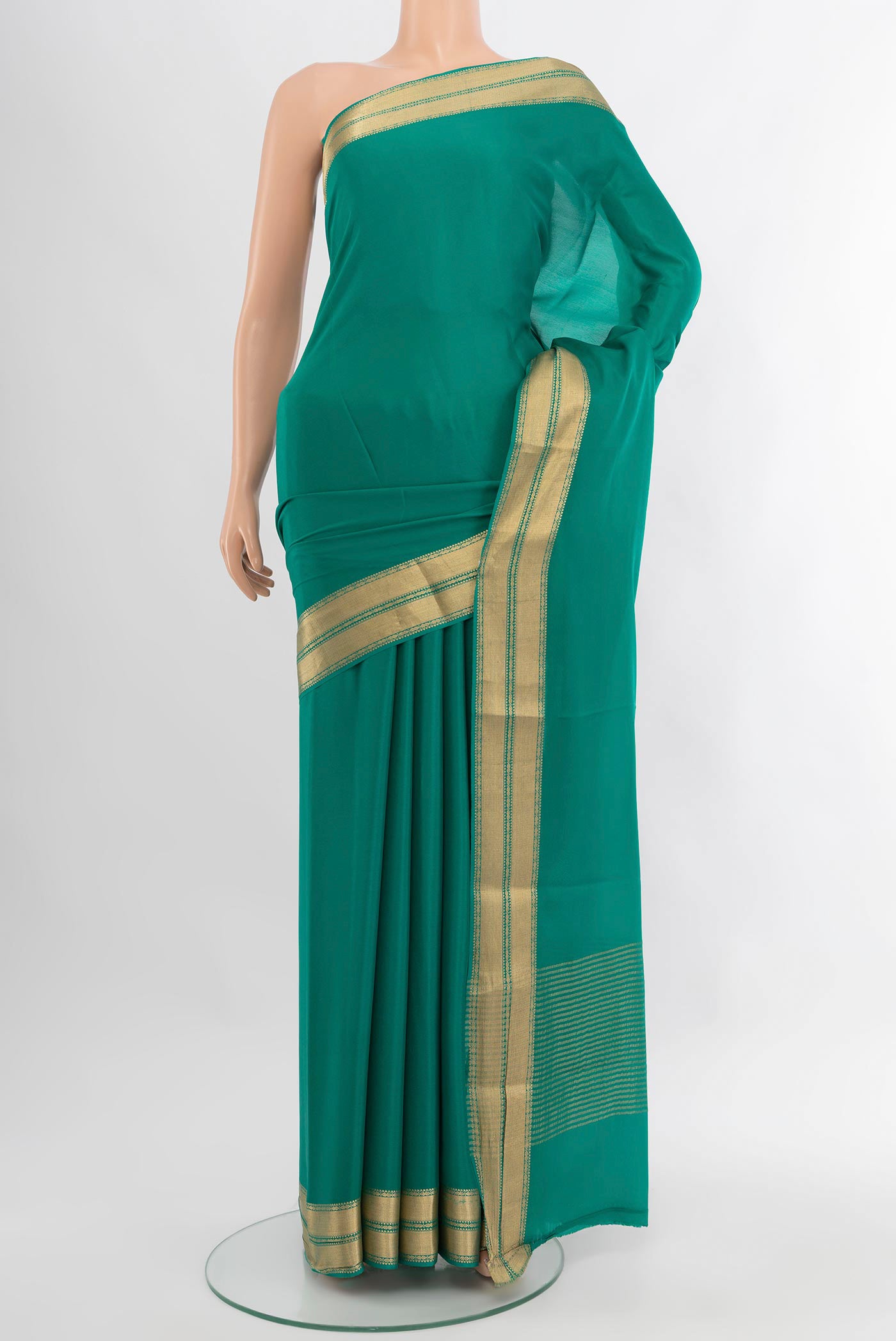 Teal Mysore Crepe Saree with Plain Body and Zari Border.  displayed on a mannequin