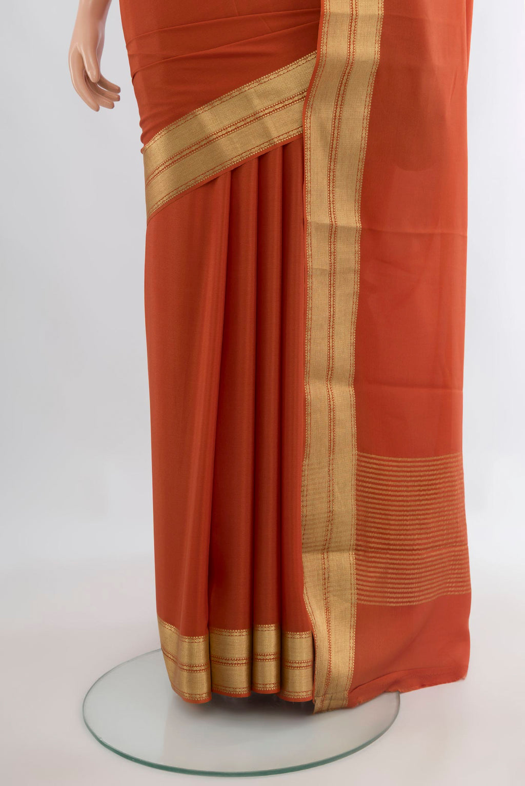 Pleats and pallu of Orange Mysore Crepe Saree with Plain Body and Zari Border. 