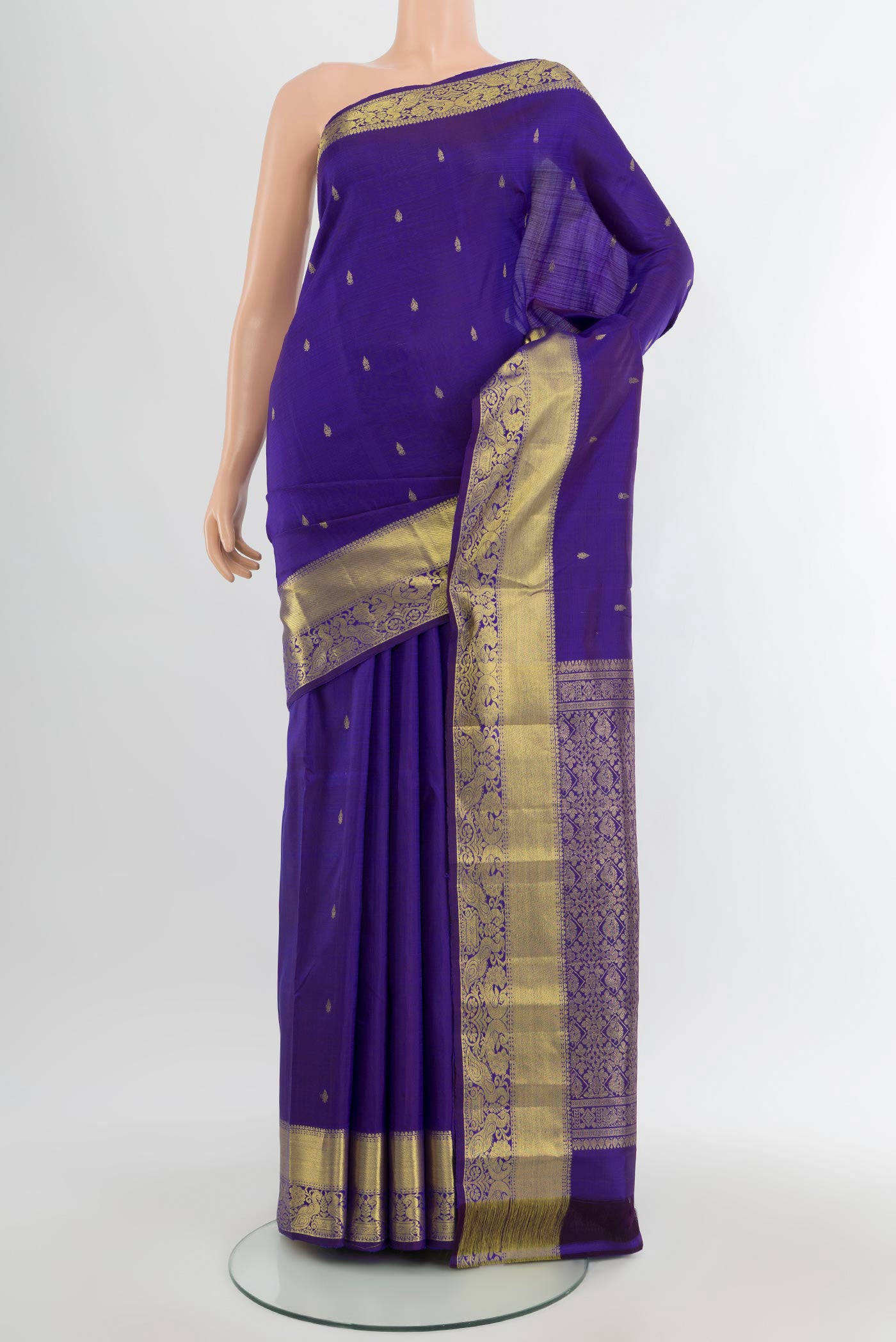 Violet Kanchipuram Silk Saree with Zari Butta on the body and Zari Border.  displayed on a mannequin