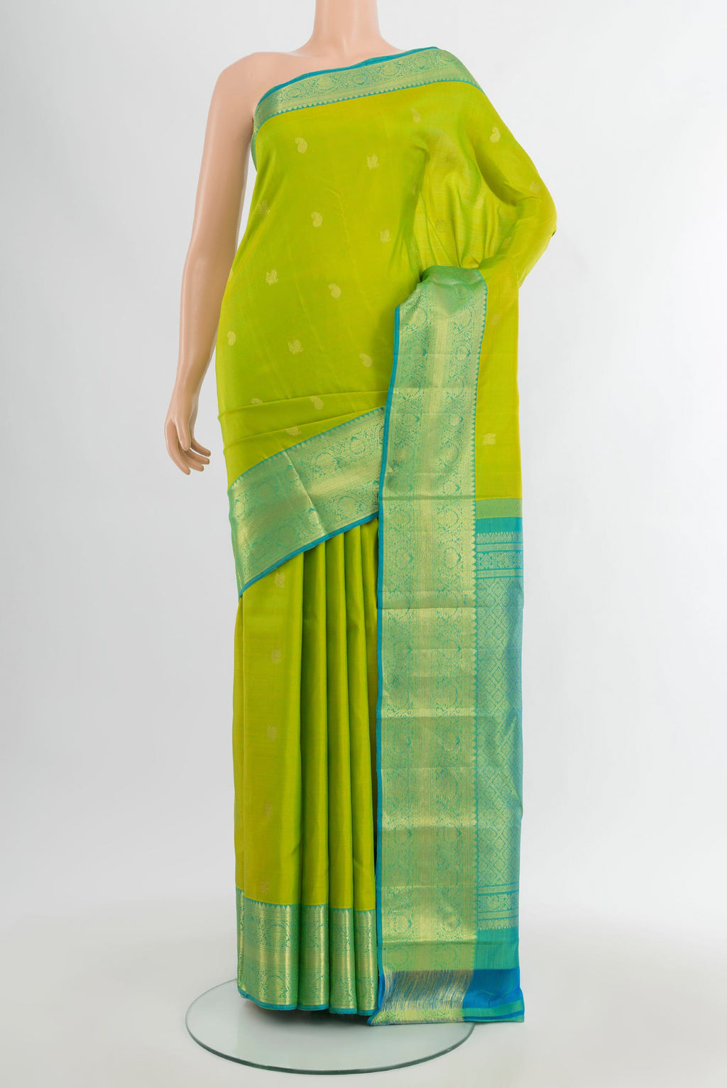 Parrot Green Kanchipuram Silk Saree with Zari Butta on the body and Zari Border.  displayed on a mannequin