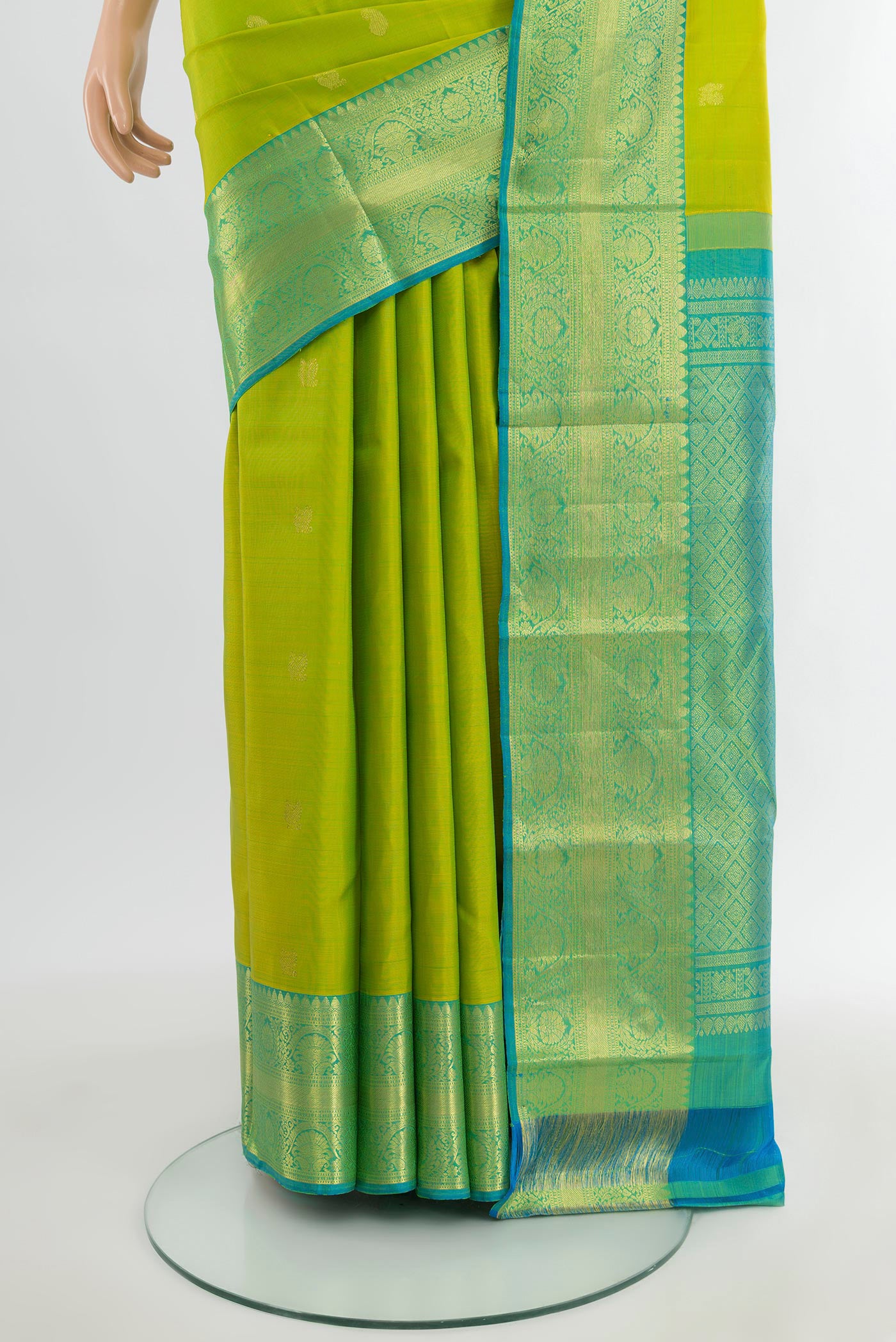 Pleats and pallu of Parrot Green Kanchipuram Silk Saree with Zari Butta on the body and Zari Border. 