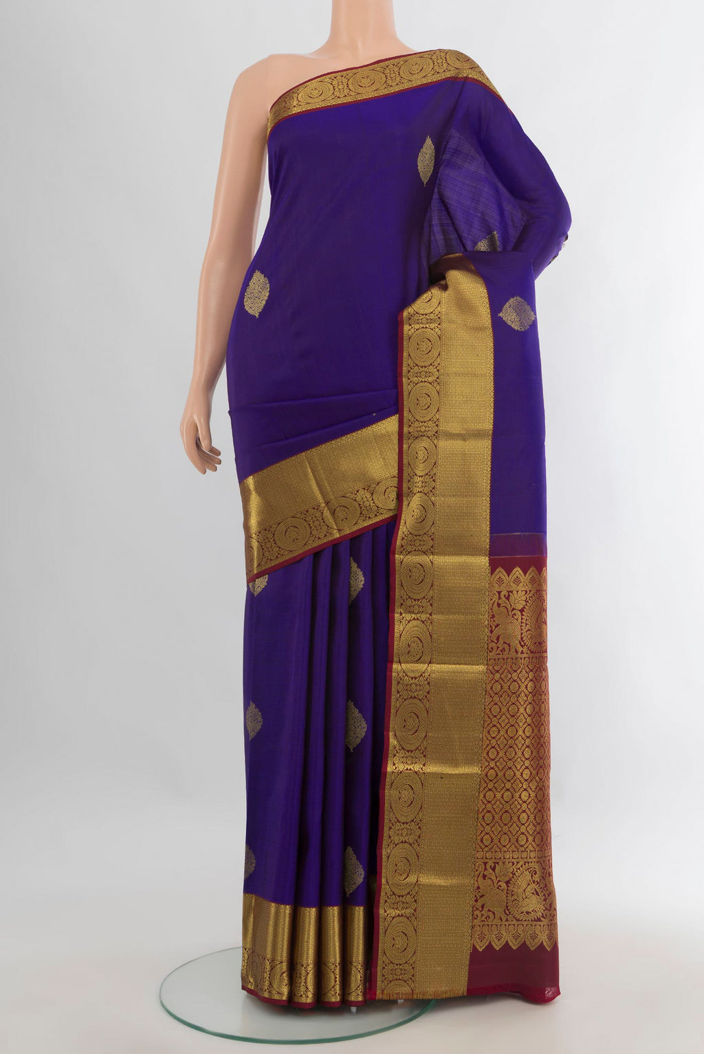 Pure Silk Dark Blue Kanchipuram Saree with Zari Butta on the body and Zari Border.  displayed on a mannequin