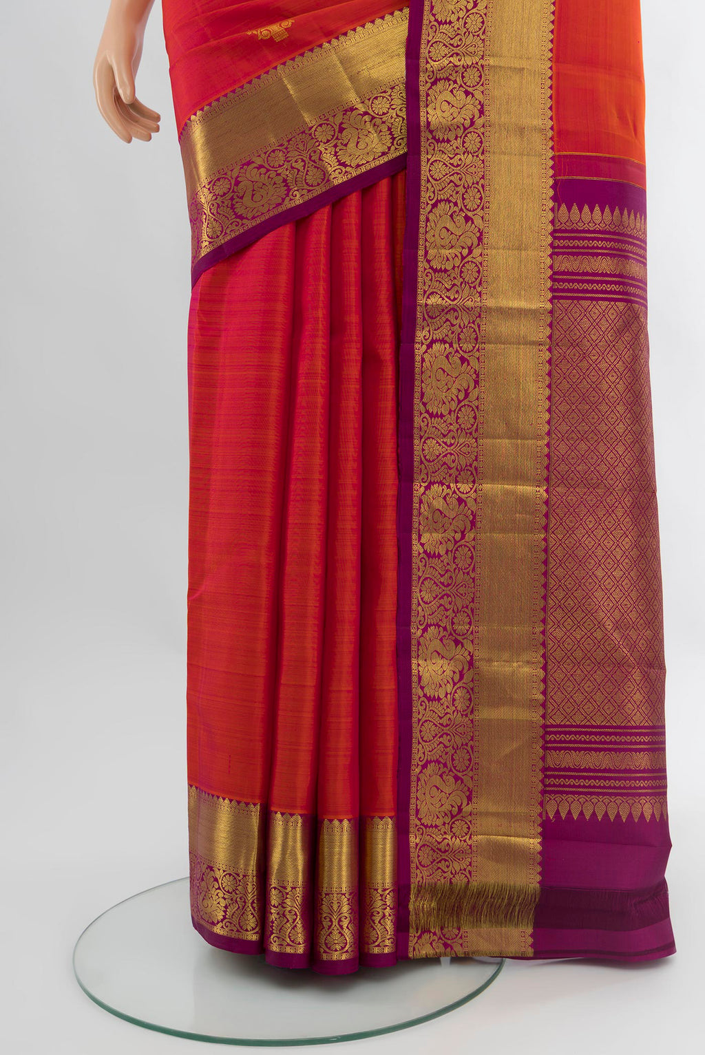 Pleats and pallu of Orange Kanchipuram Silk Saree with Zari Butta on the body and Zari Border. 
