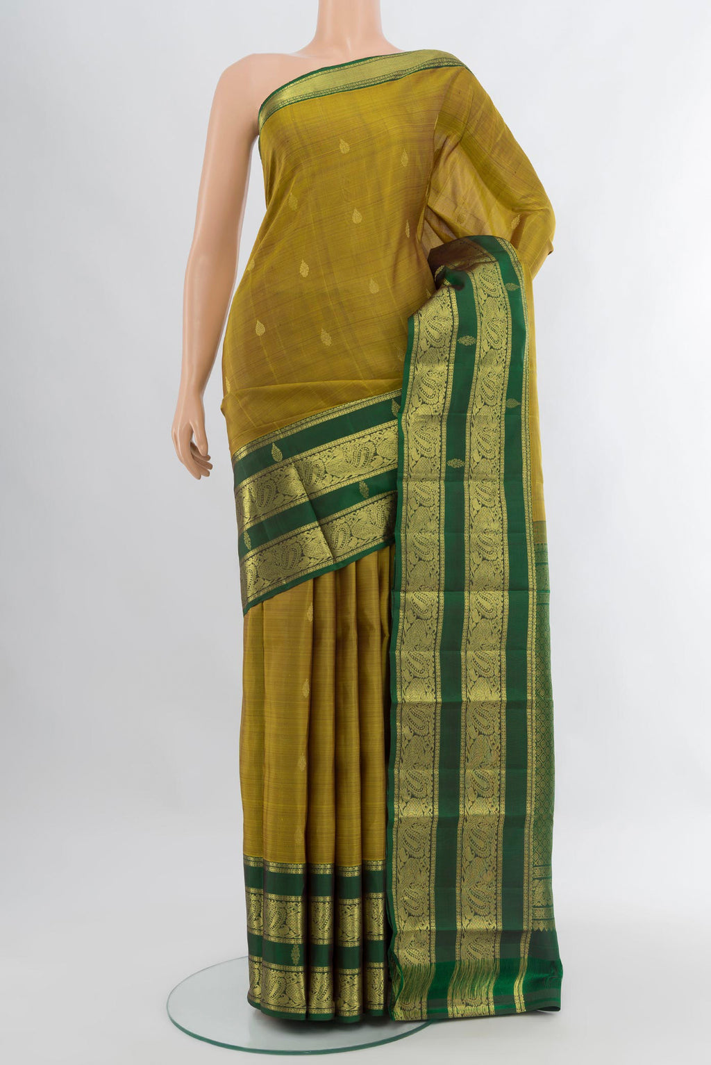 Mehandi Green Kanchipuram Silk Saree with Zari Butta on the body and Zari Border.  displayed on a mannequin