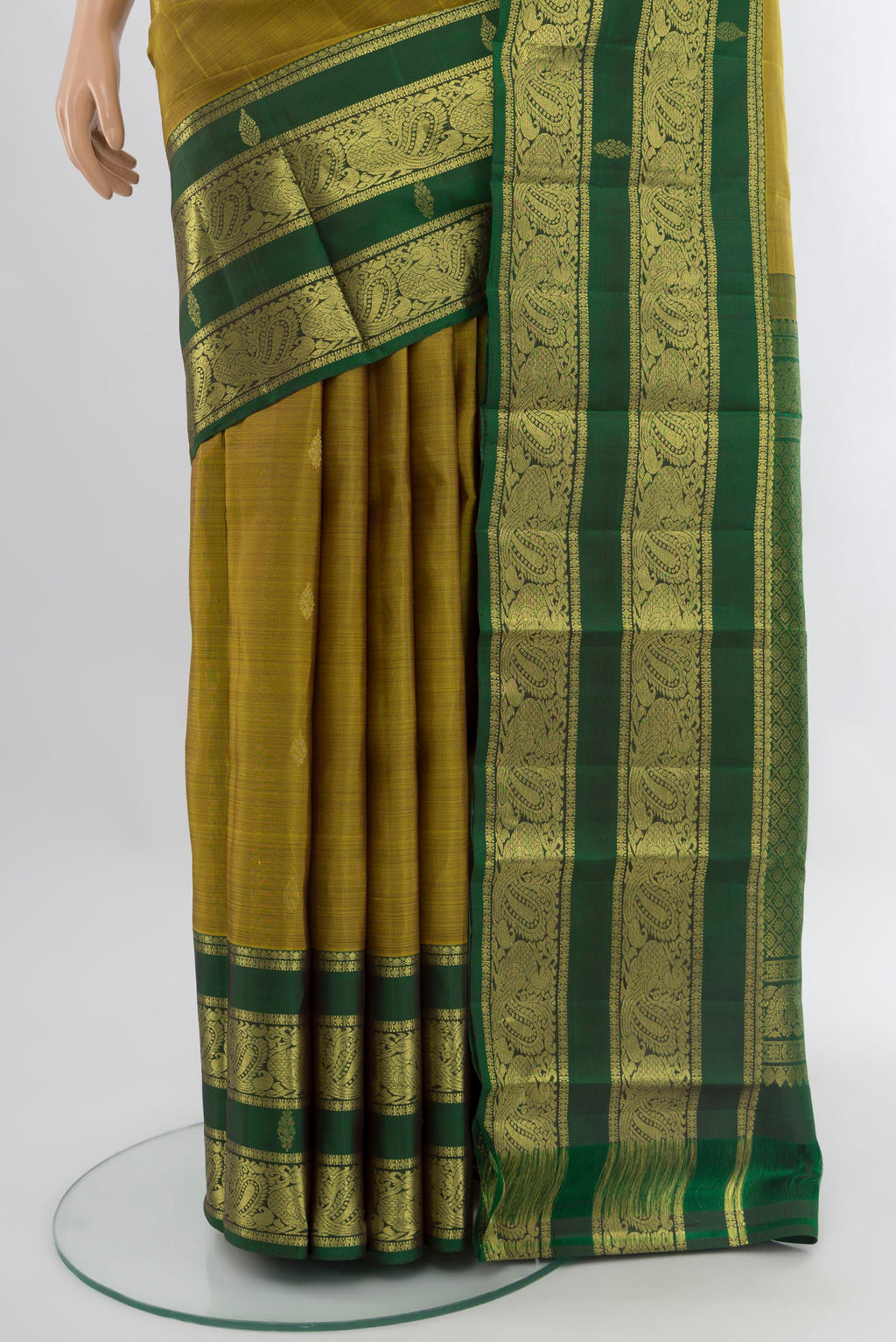 Pleats and pallu of Mehandi Green Kanchipuram Silk Saree with Zari Butta on the body and Zari Border. 