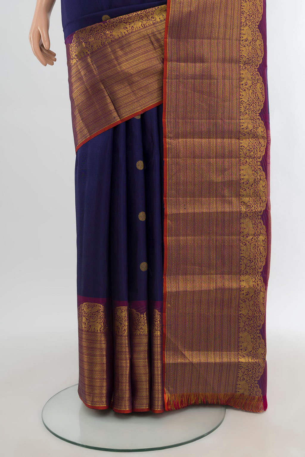 Pleats and pallu of Navy Blue Kanchipuram Silk Saree with Zari Butta on the body and Fancy Border. 