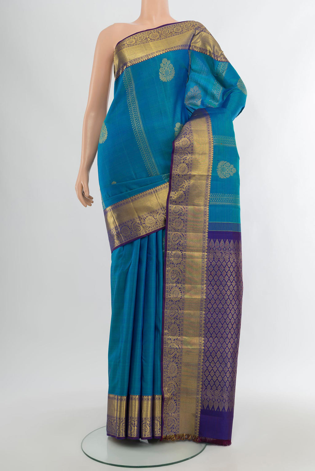 Blue Kanchipuram Silk Saree with Zari Butta on the body and Zari Border.  displayed on a mannequin