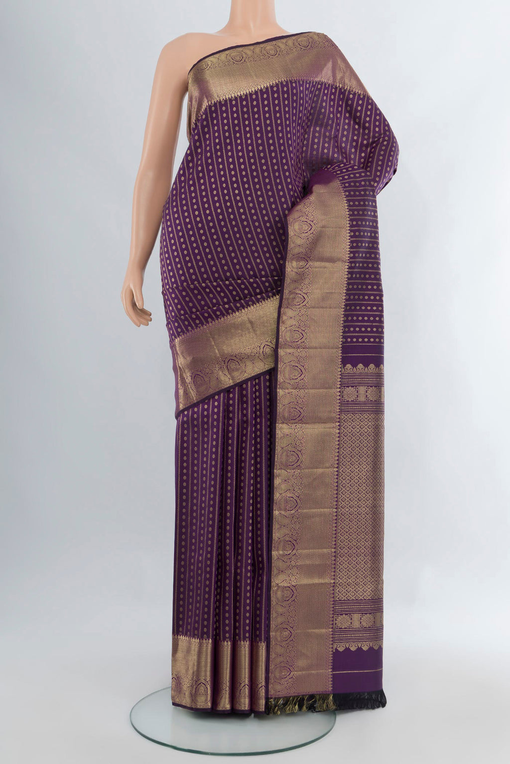 Violet Kanjivaram Silk Saree with Zari Butta on the body and Zari Border.  displayed on a mannequin