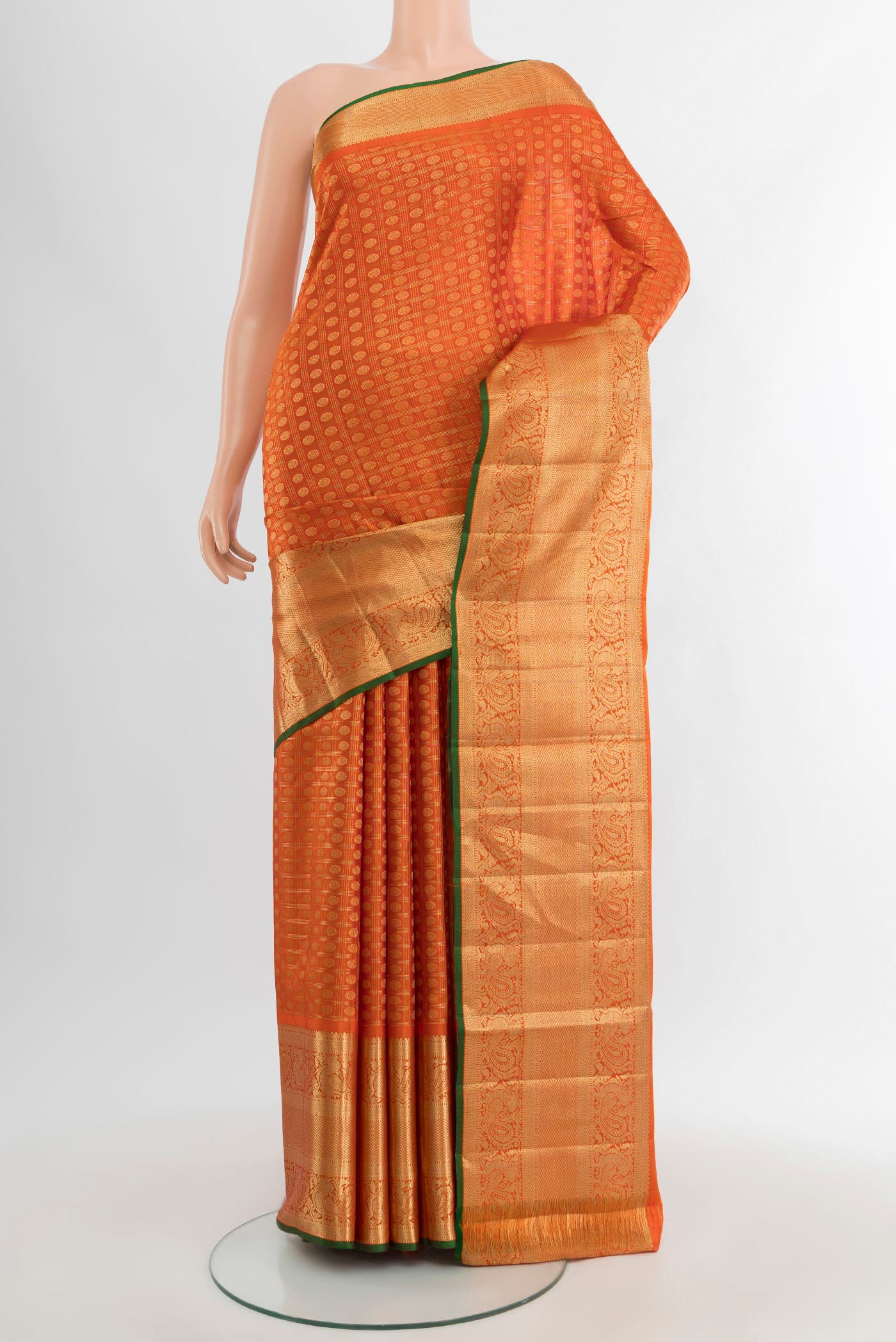 Orange Kanjivaram Silk Saree with Zari Butta on the body and Zari Border.  displayed on a mannequin