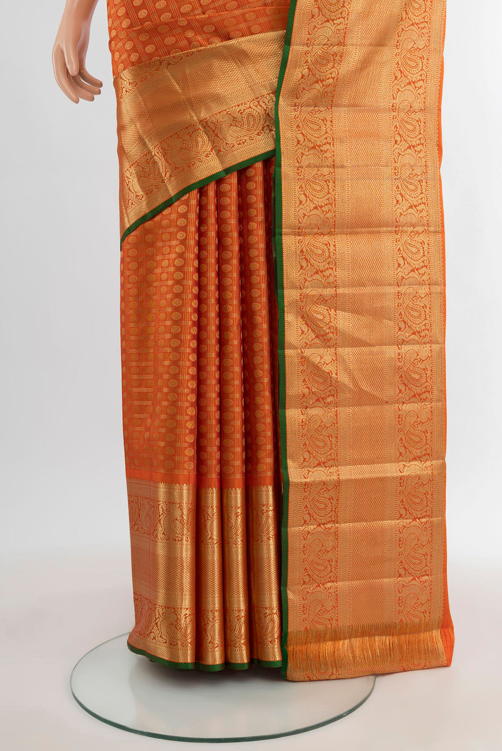 Pleats and pallu of Orange Kanjivaram Silk Saree with Zari Butta on the body and Zari Border. 