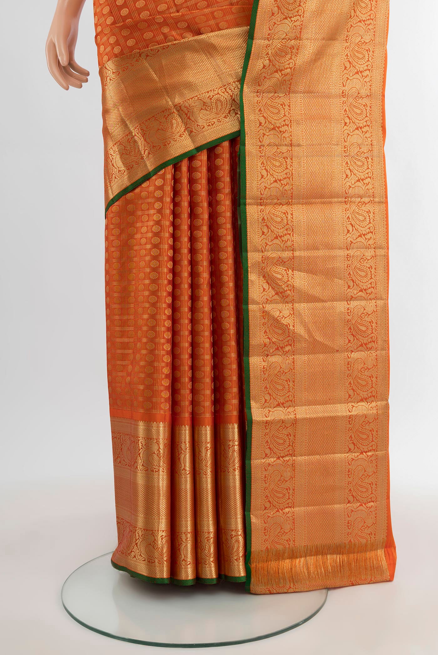 Pleats and pallu of Orange Kanjivaram Silk Saree with Zari Butta on the body and Zari Border. 