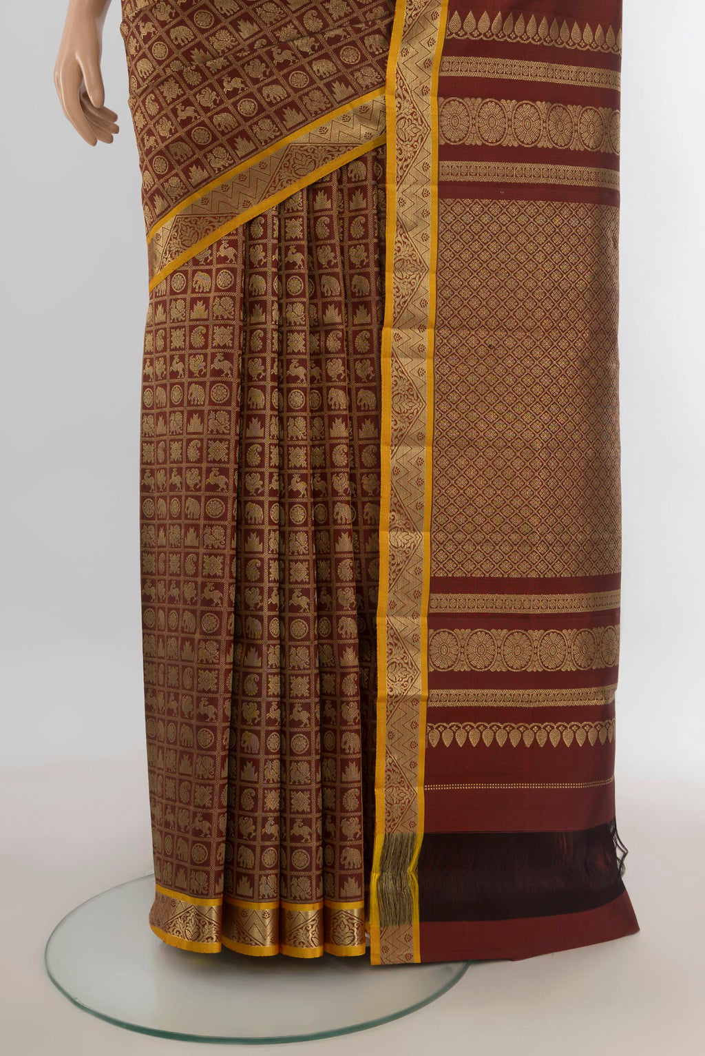 Pleats and pallu of Pure Silk Coffee Brown Kanjivaram Saree with Zari Butta on the body and Silk Border. 