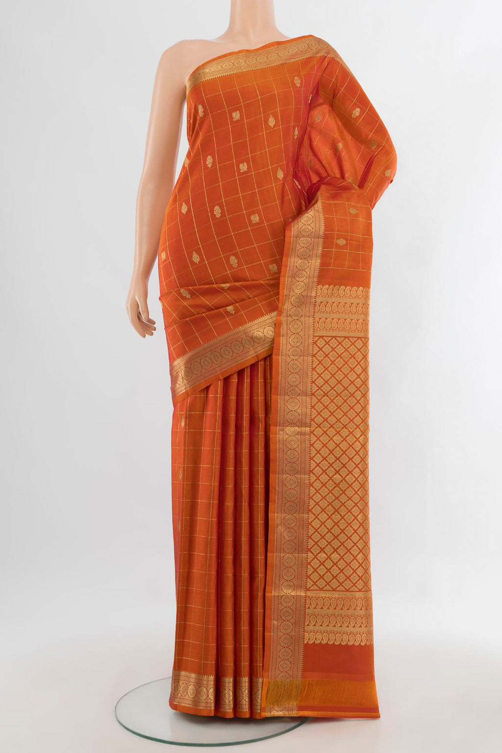 Pure Silk Rust Kanjivaram Saree with Checked design on the body and Zari Border.  displayed on a mannequin