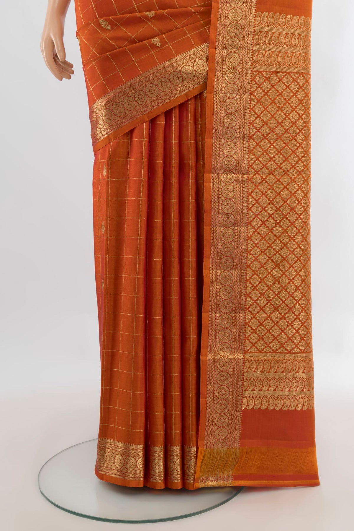 Pleats and pallu of Pure Silk Rust Kanjivaram Saree with Checked design on the body and Zari Border. 