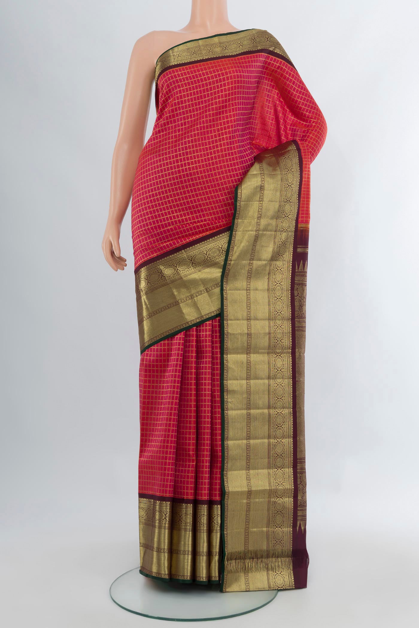 Pink Kanchipuram Silk Saree with Checked design on the body and Zari Border.  displayed on a mannequin