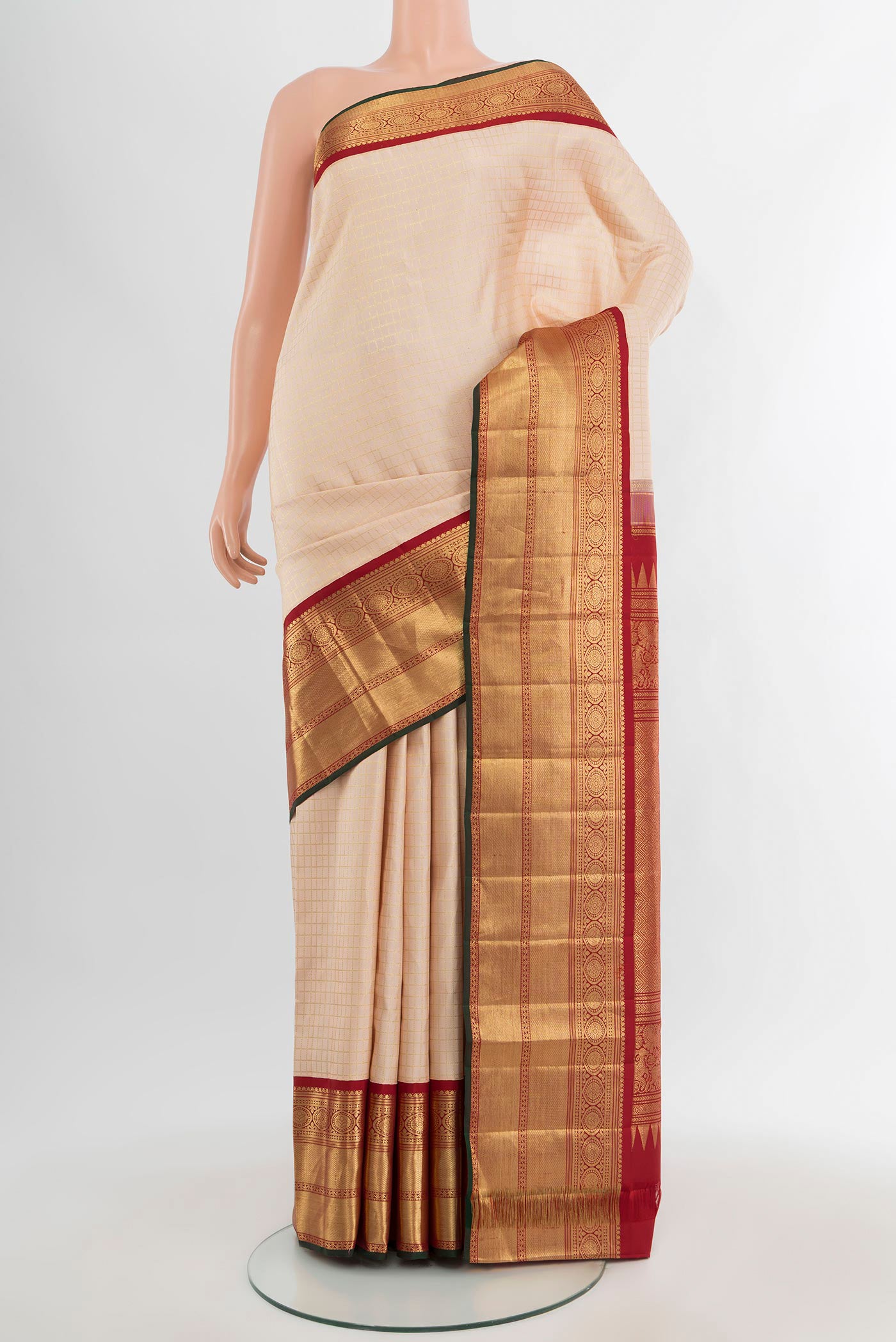 Cream Kanchipuram Silk Saree with Checked design on the body and Zari Border.  displayed on a mannequin
