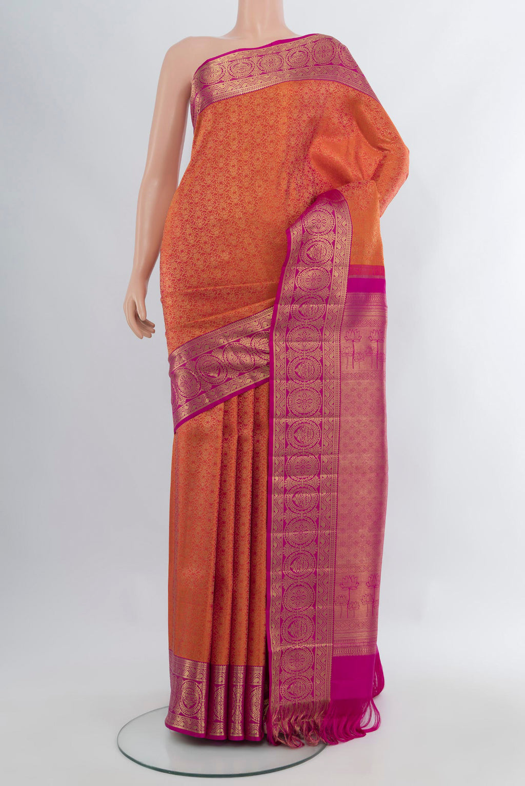 Brick Orange Kanchipuram Silk Saree with Zari Brocade on the body and Zari Border.  displayed on a mannequin