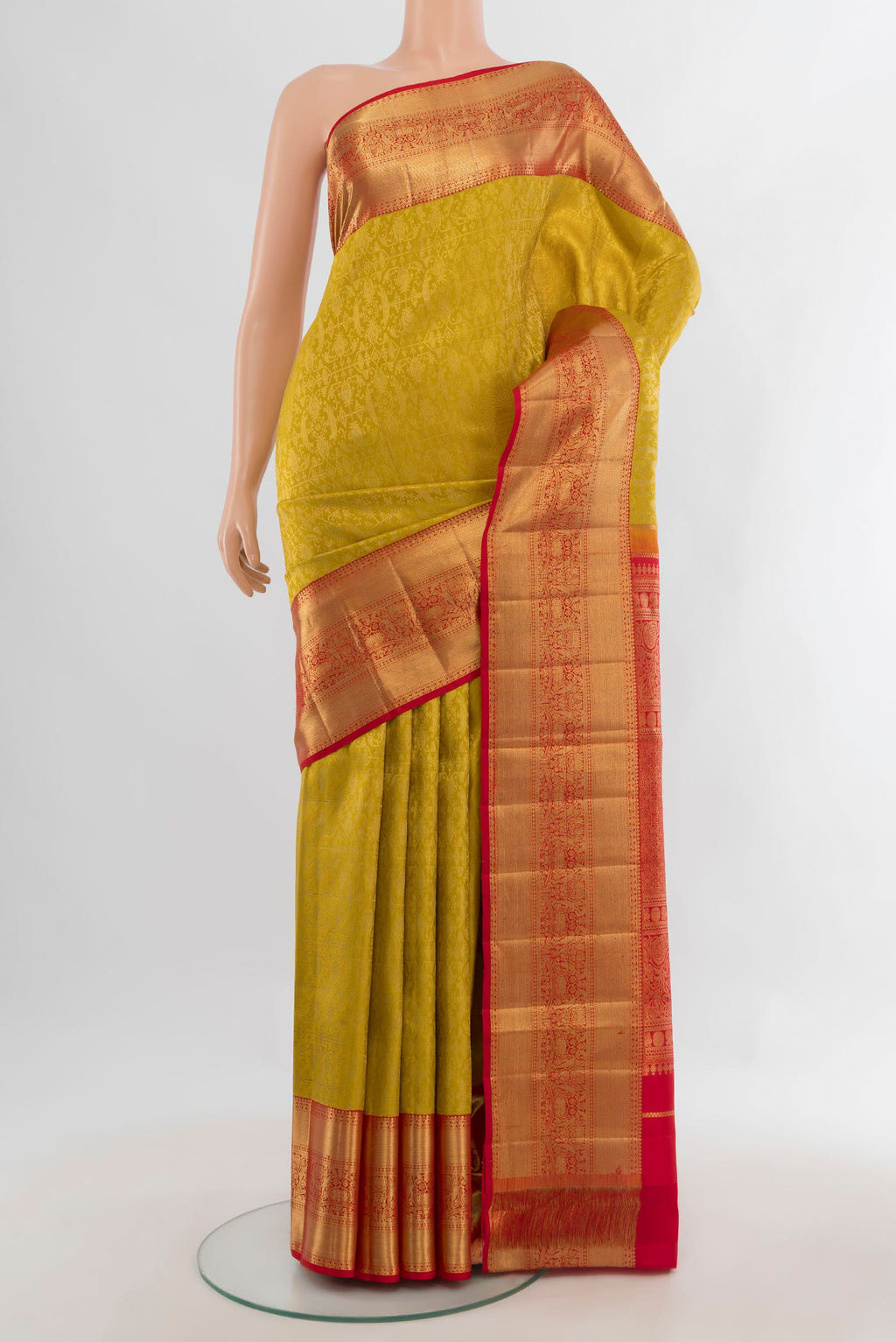 Pure Silk Mustard Kanchipuram Saree with Zari Butta on the body and Zari Border.  displayed on a mannequin