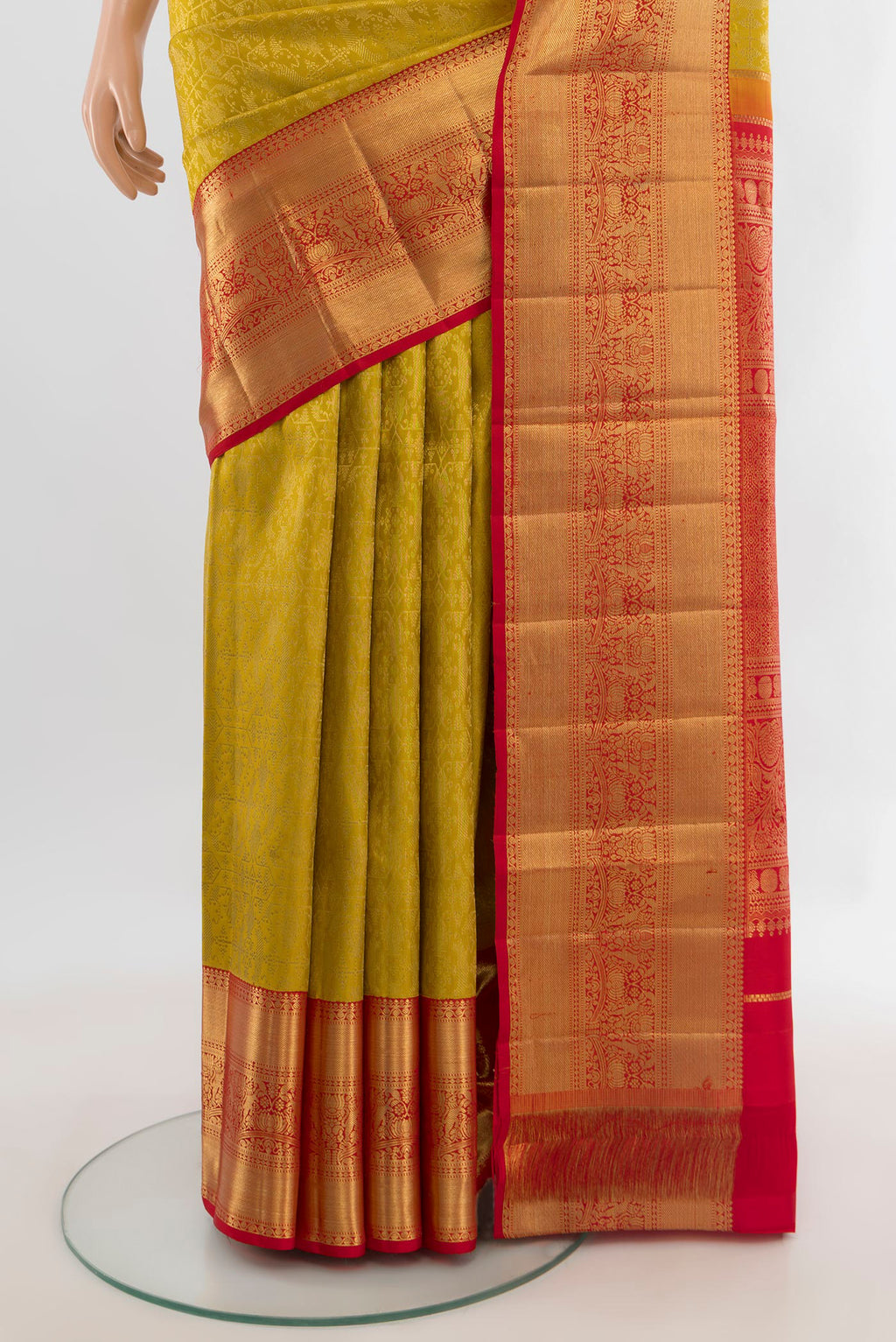 Pleats and pallu of Pure Silk Mustard Kanchipuram Saree with Zari Butta on the body and Zari Border. 