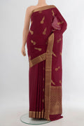 Maroon Mysore Crepe Saree with Zari Butta on the body and Zari Border.  displayed on a mannequin