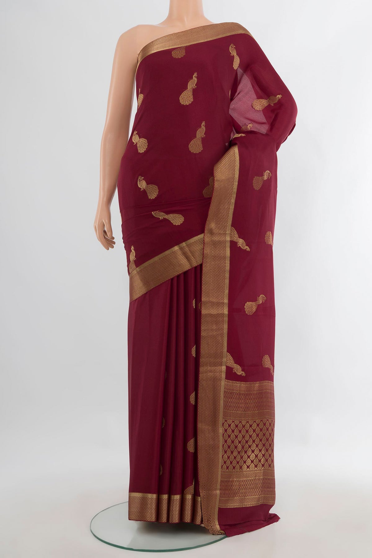 Maroon Mysore Crepe Saree with Zari Butta on the body and Zari Border.  displayed on a mannequin