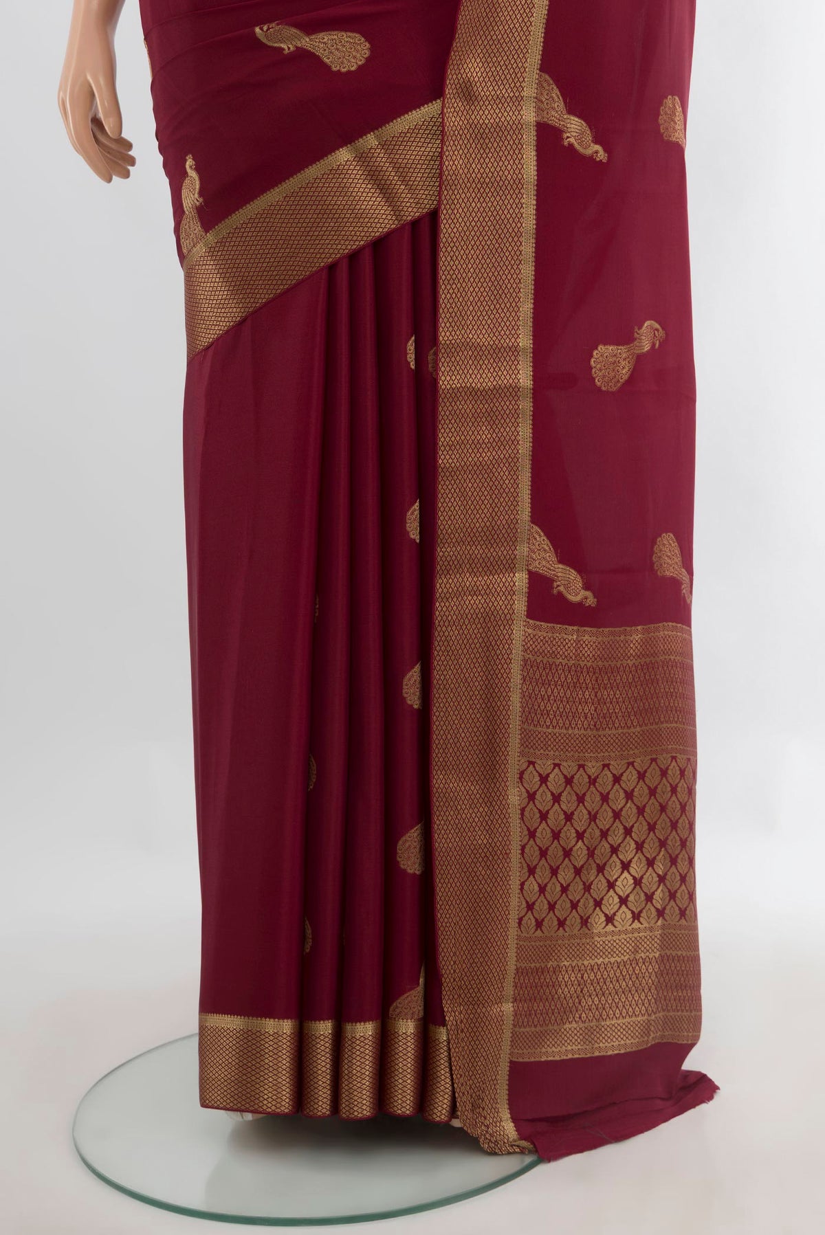Pleats and pallu of Maroon Mysore Crepe Saree with Zari Butta on the body and Zari Border. 