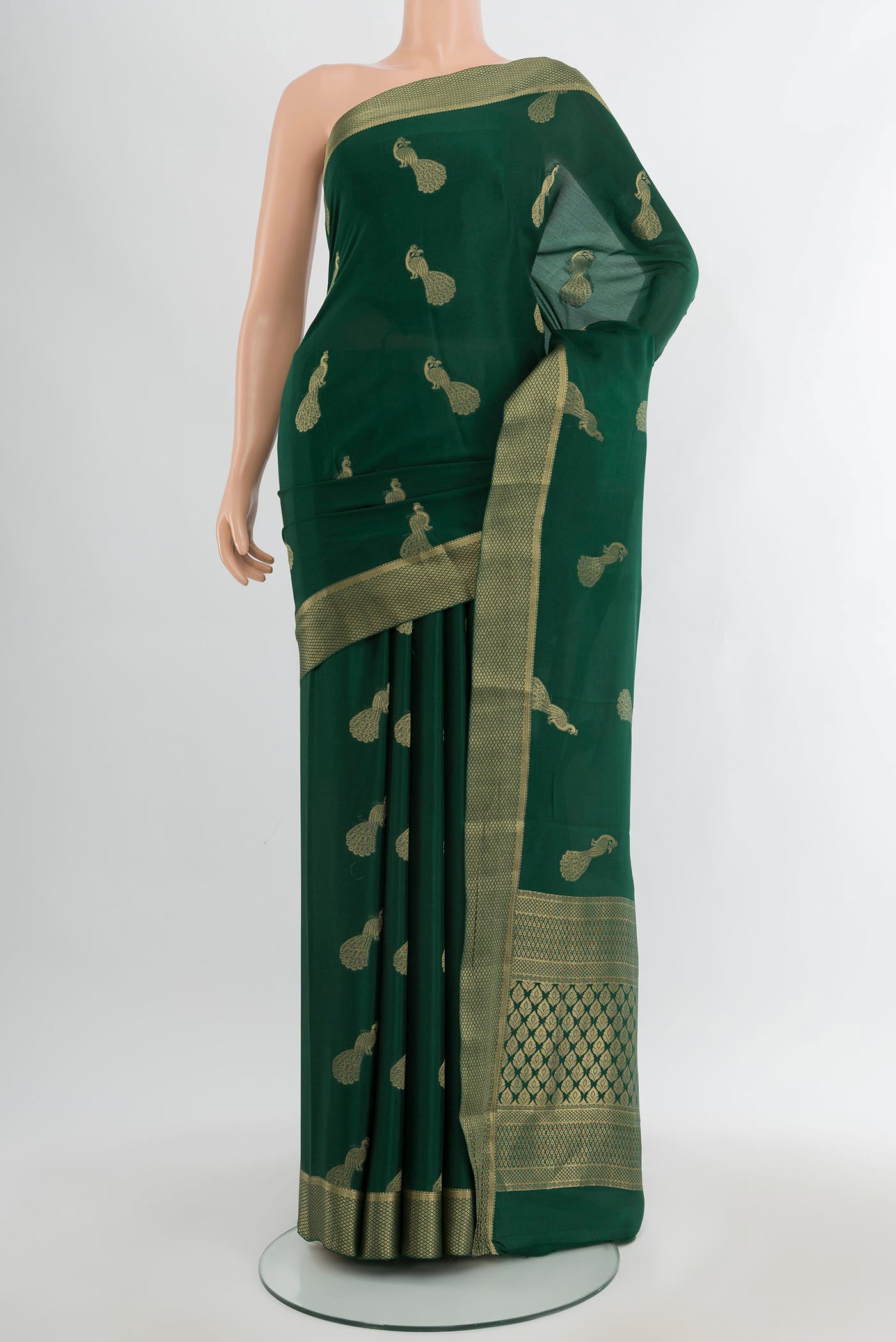 Bottle Green Mysore Crepe Saree with Zari Butta on the body and Zari Border.  displayed on a mannequin