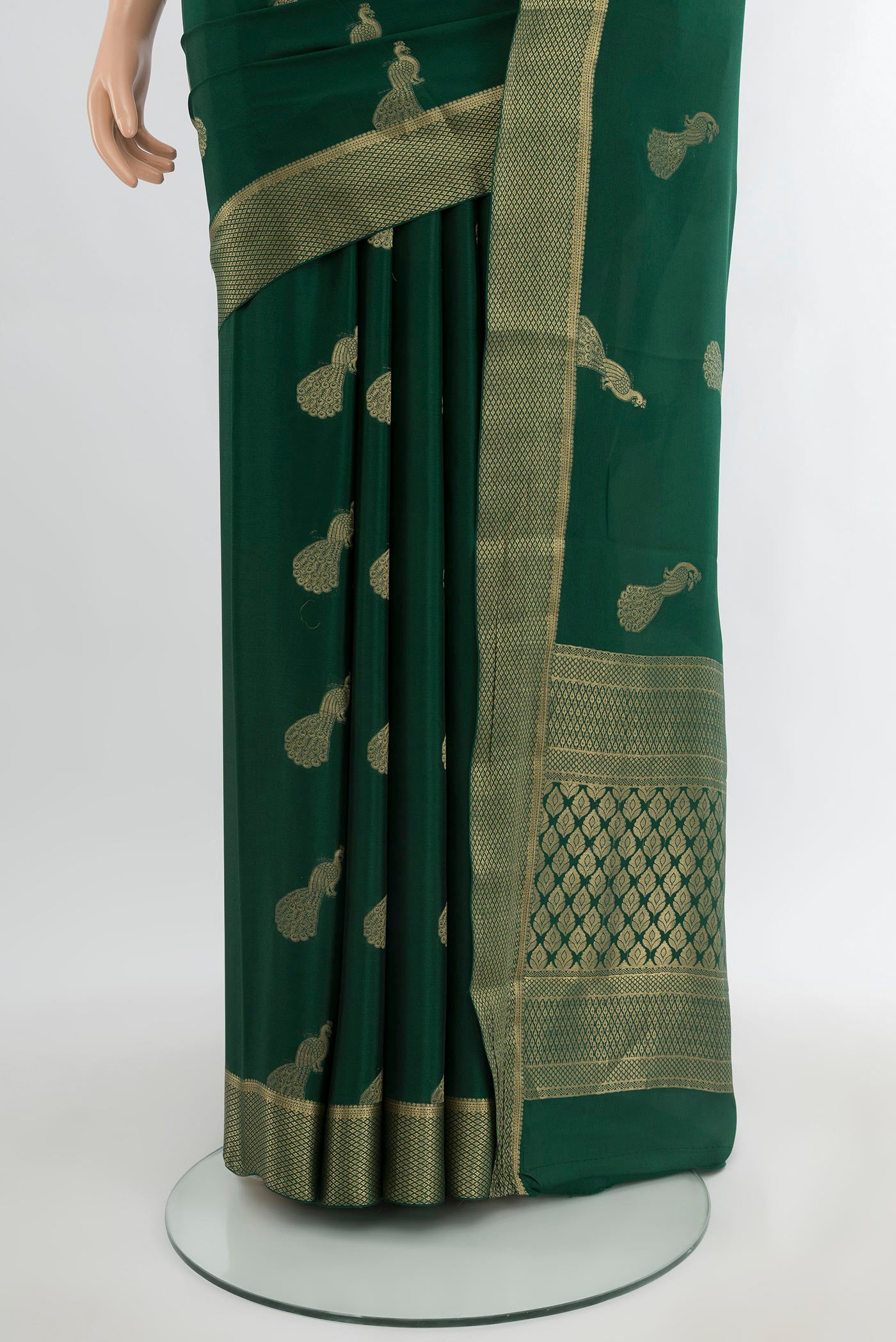 Pleats and pallu of Bottle Green Mysore Crepe Saree with Zari Butta on the body and Zari Border. 