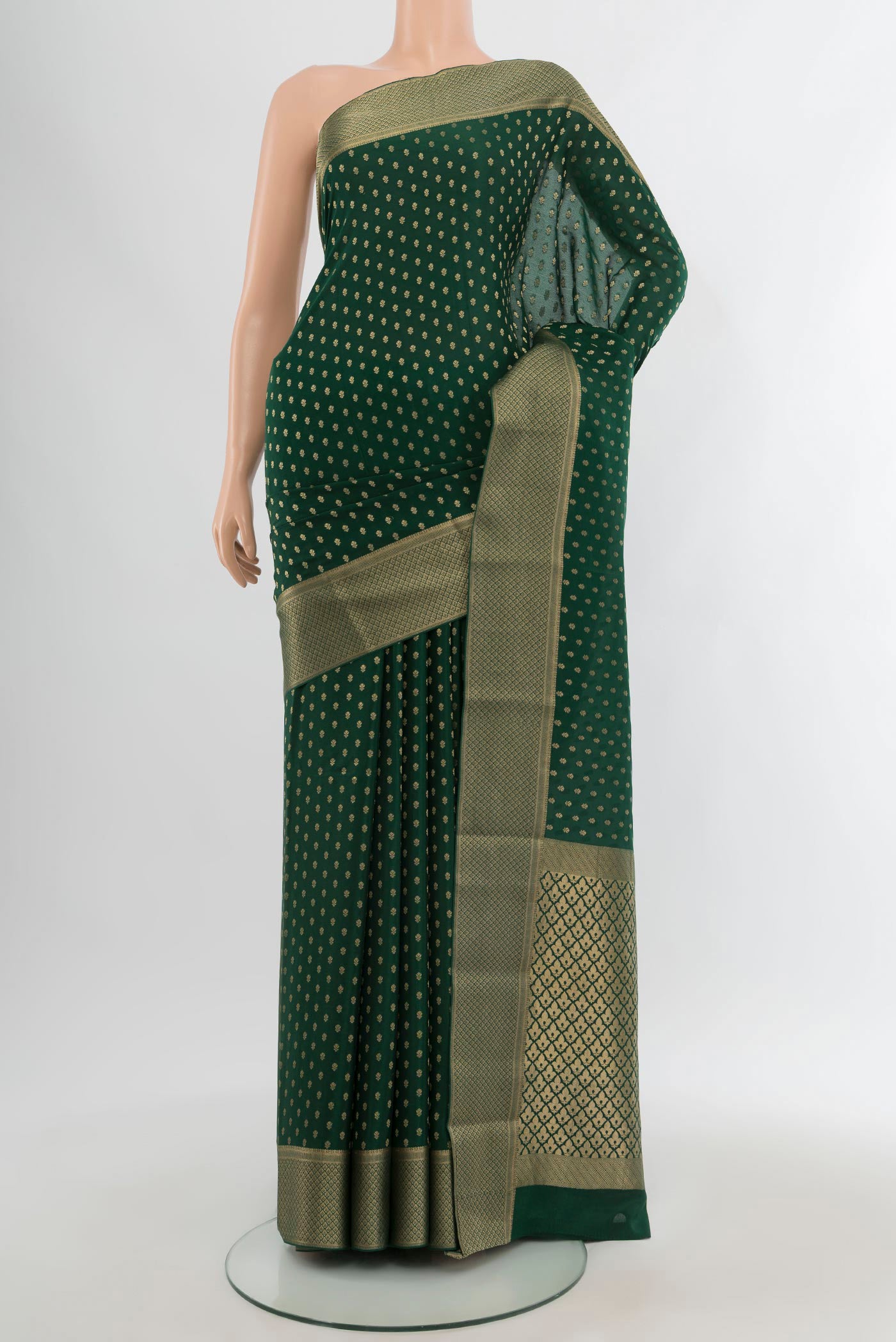 Bottle Green Mysore Crepe Saree with Zari Butta on the body and Zari Border.  displayed on a mannequin