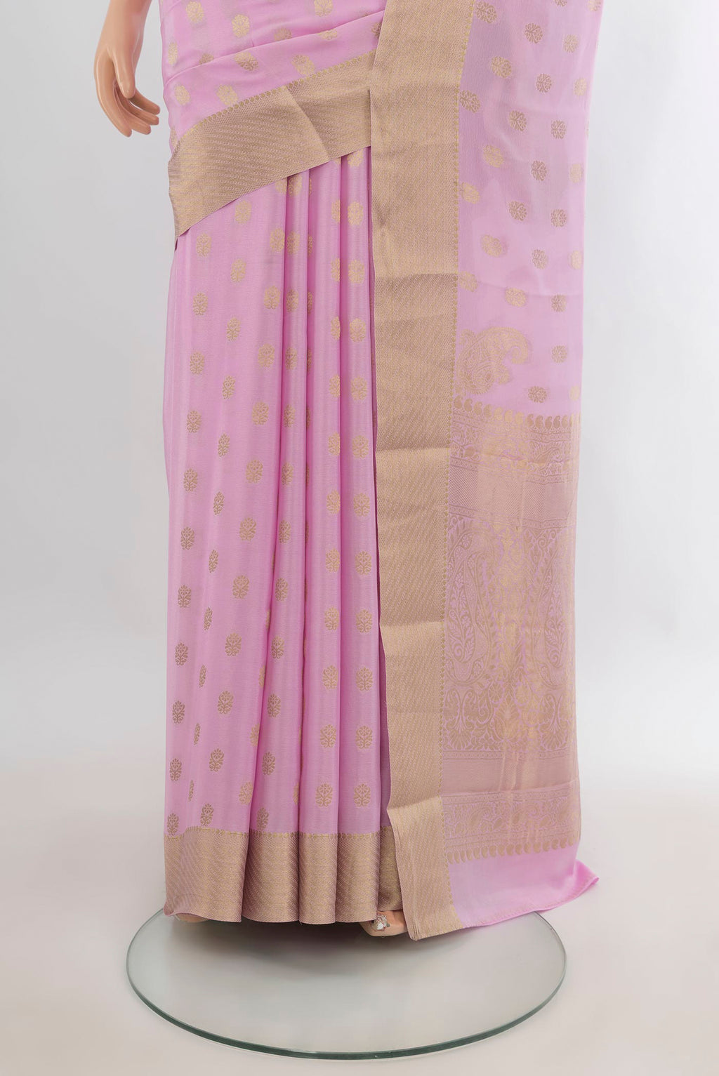 Pleats and pallu of Rose pink Mysore Crepe Saree with Zari Butta on the body and Zari Border. 