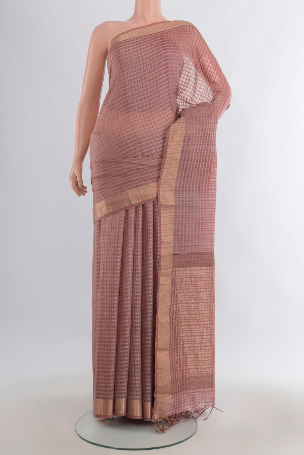 Peach Tussar Saree with Checked design on the body and Zari Border.  displayed on a mannequin