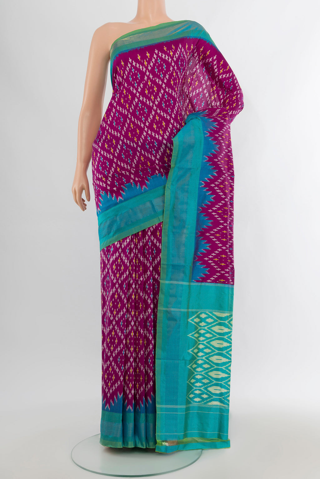 Magenta Pochampally Silk Saree with Ikat design on the body and Zari Border.  displayed on a mannequin
