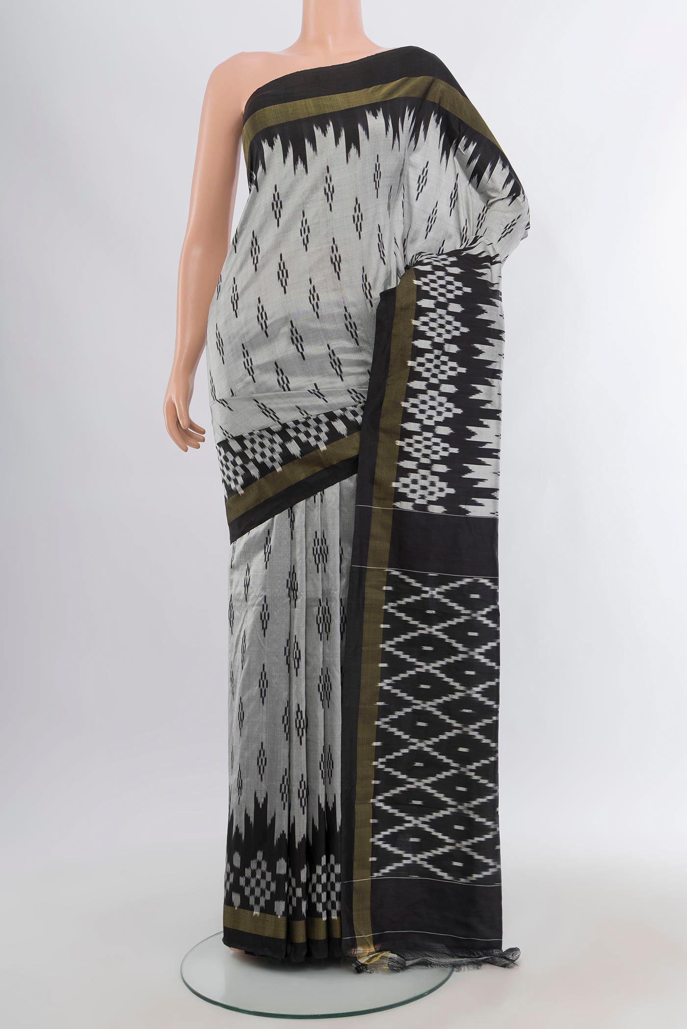 Grey Pochampally Silk Saree with Ikat design on the body and Ikat Border.  displayed on a mannequin