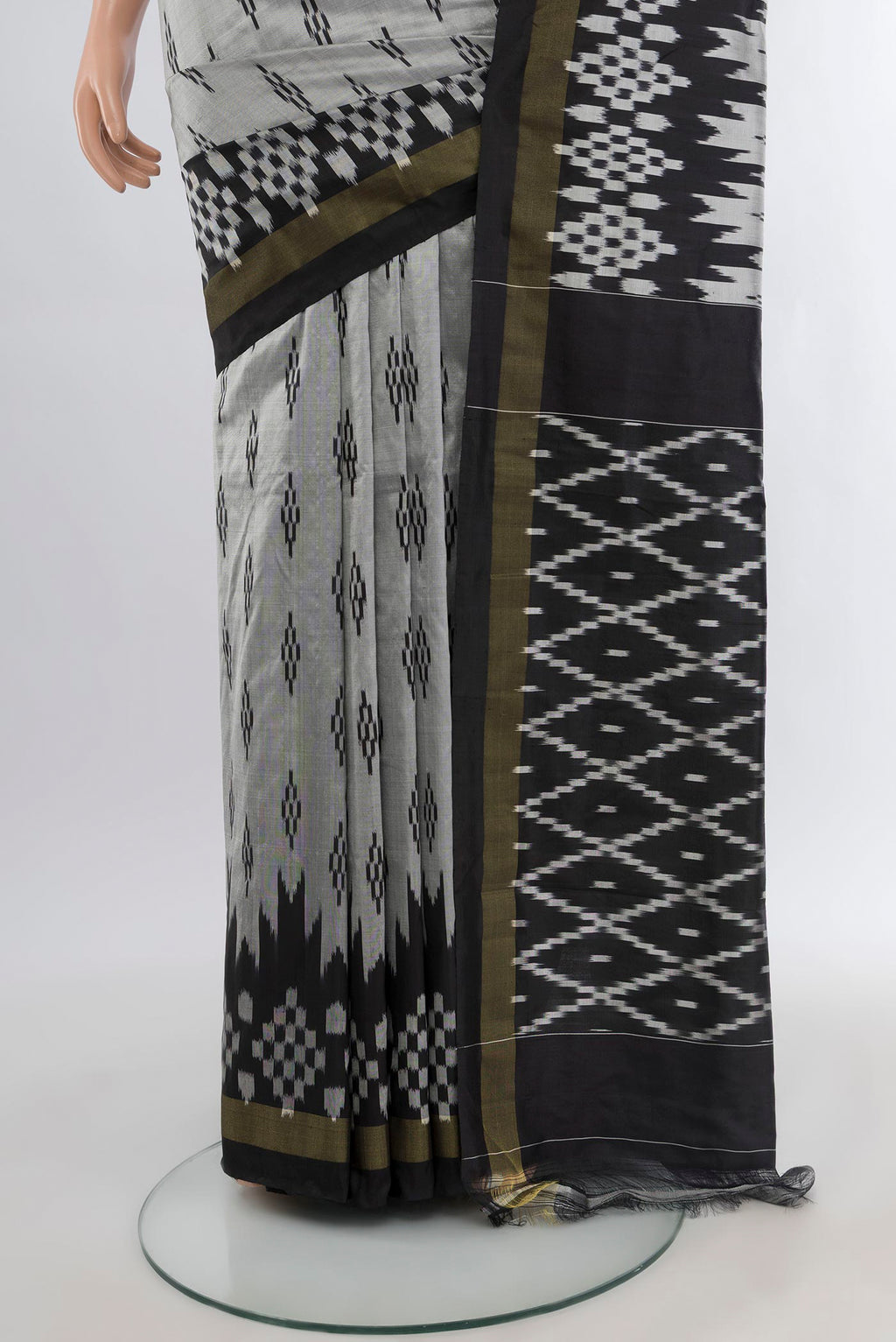 Pleats and pallu of Grey Pochampally Silk Saree with Ikat design on the body and Ikat Border. 