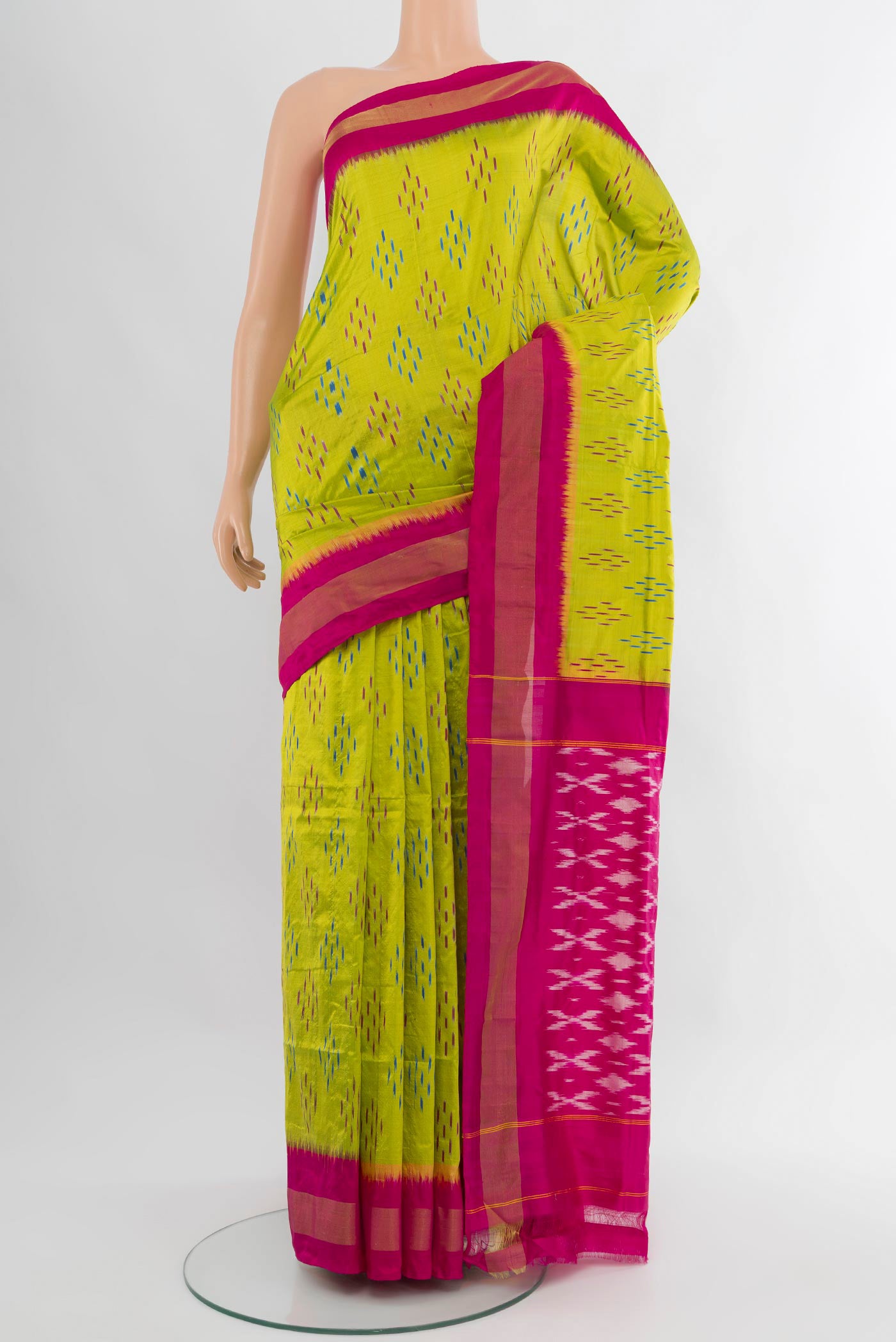 Parrot Green Pochampally Silk Saree with Ikat design on the body and Zari Border.  displayed on a mannequin