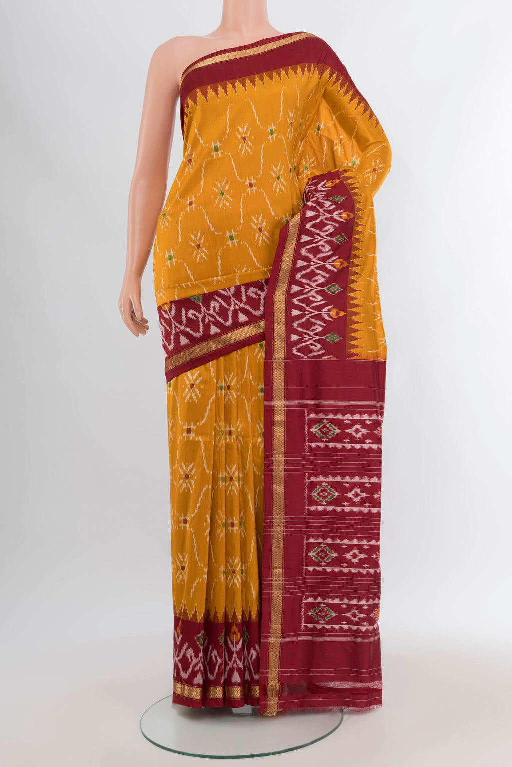 Mustard Pochampally Silk Saree with Pure Ikat on the body and Ikat Border.  displayed on a mannequin