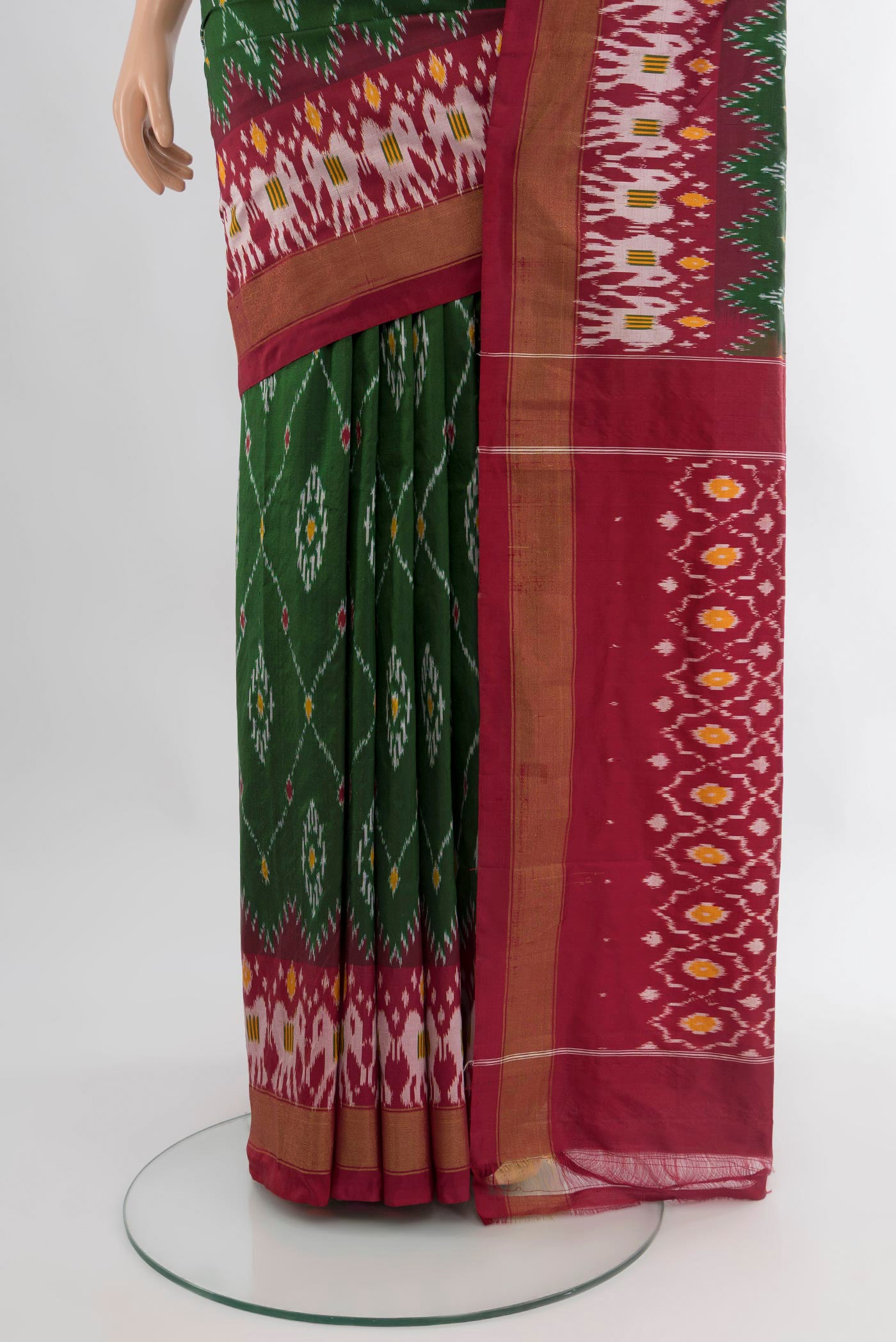 Pleats and pallu of Bottle Green Pochampally Silk Saree with Ikat design on the body and Zari Border. 